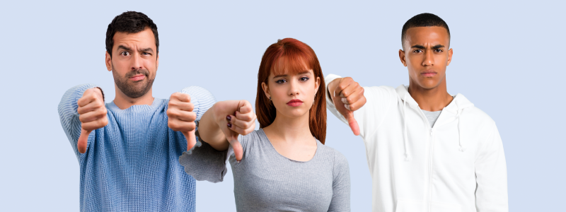 people pointing their thumbs down with unhappy faces