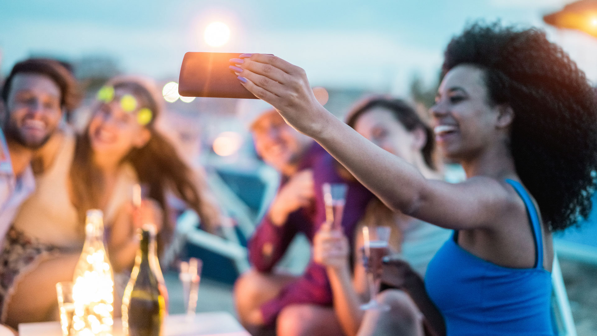 Photo of a woman taking a selfie of her and her group of friends