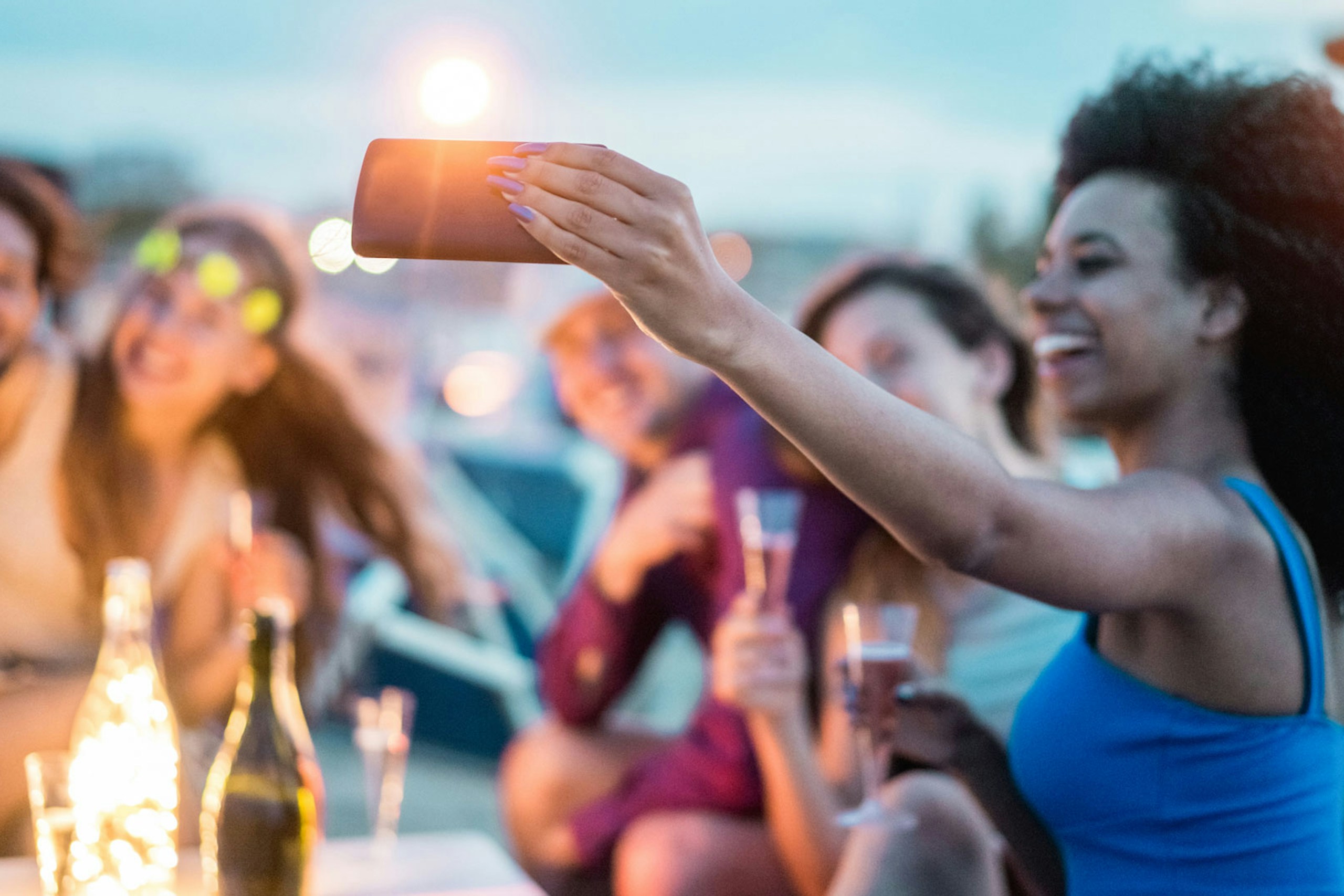Photo of a woman taking a selfie of her and her group of friends