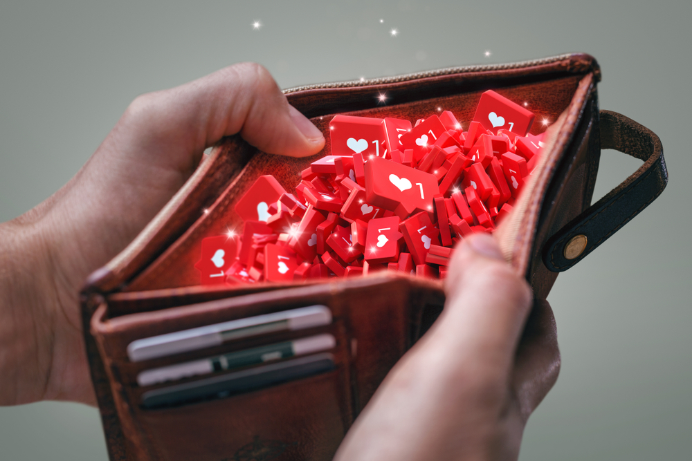 A hand holding a wallet filled with 'Like' icons