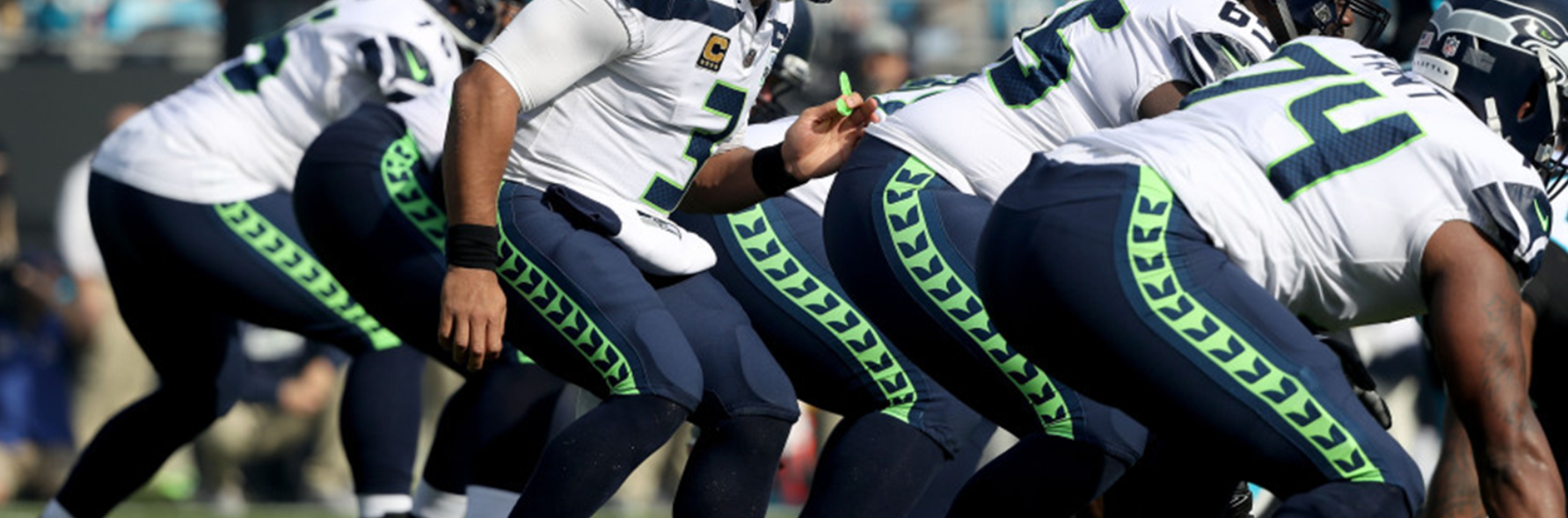 Backview of football players crouching 