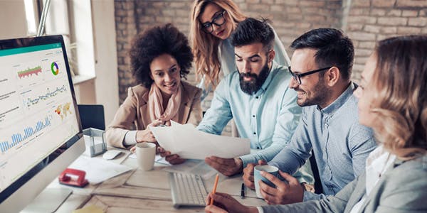 people looking at paper to analyse return on investment