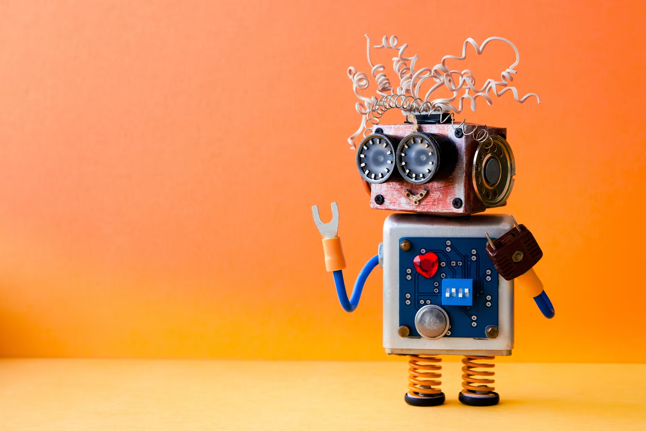Un robot-jouet fabriqué à partir de pièces détachées provenant de différentes machines ou de pièces mécaniques, telles que des ressorts, des prises électriques et des fils. Il pourrait s'agir d'un robot à vocation sociale qui répondrait à des questions sur la manière de construire des robots similaires pour les médias sociaux.