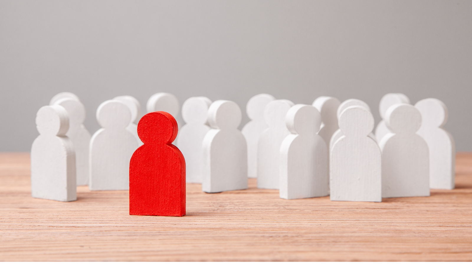 Petit bonhomme rouge autour d'autres petits bonhommes blancs