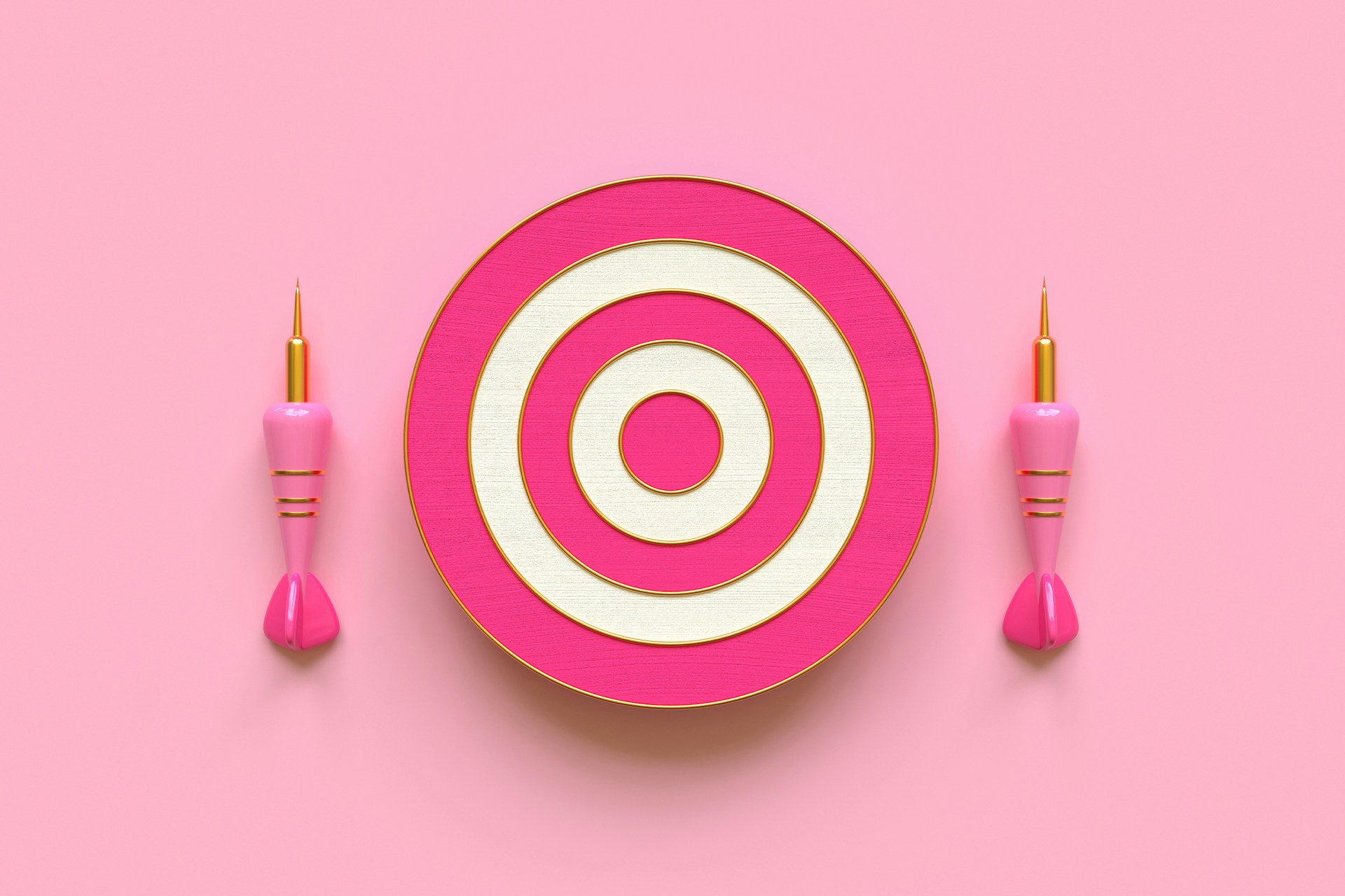 A bullseye dartboard with two pink darts next to it.