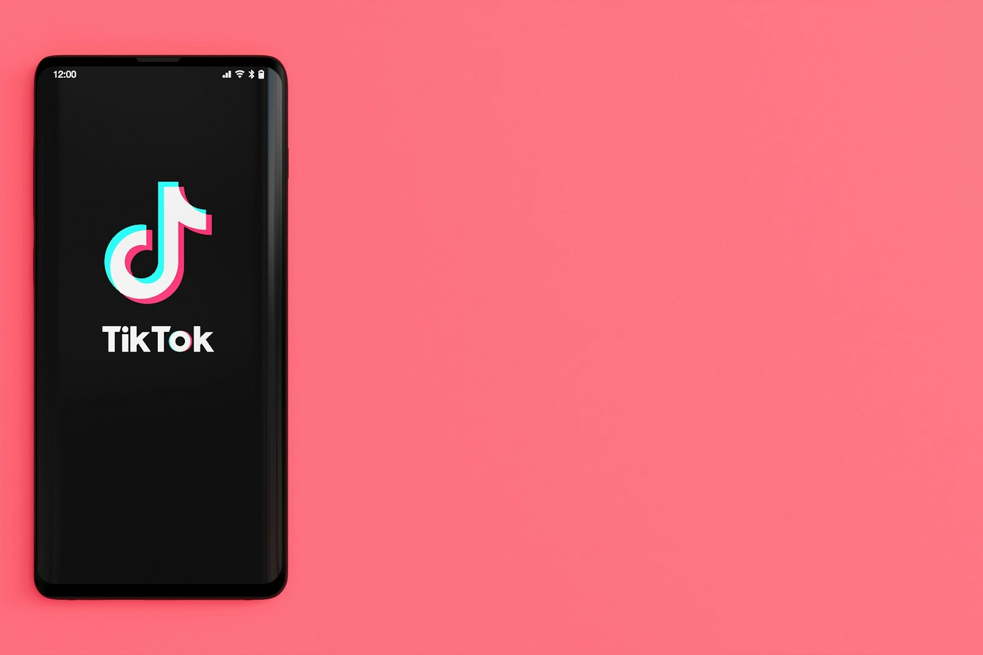 TikTok logo in phone with pink background