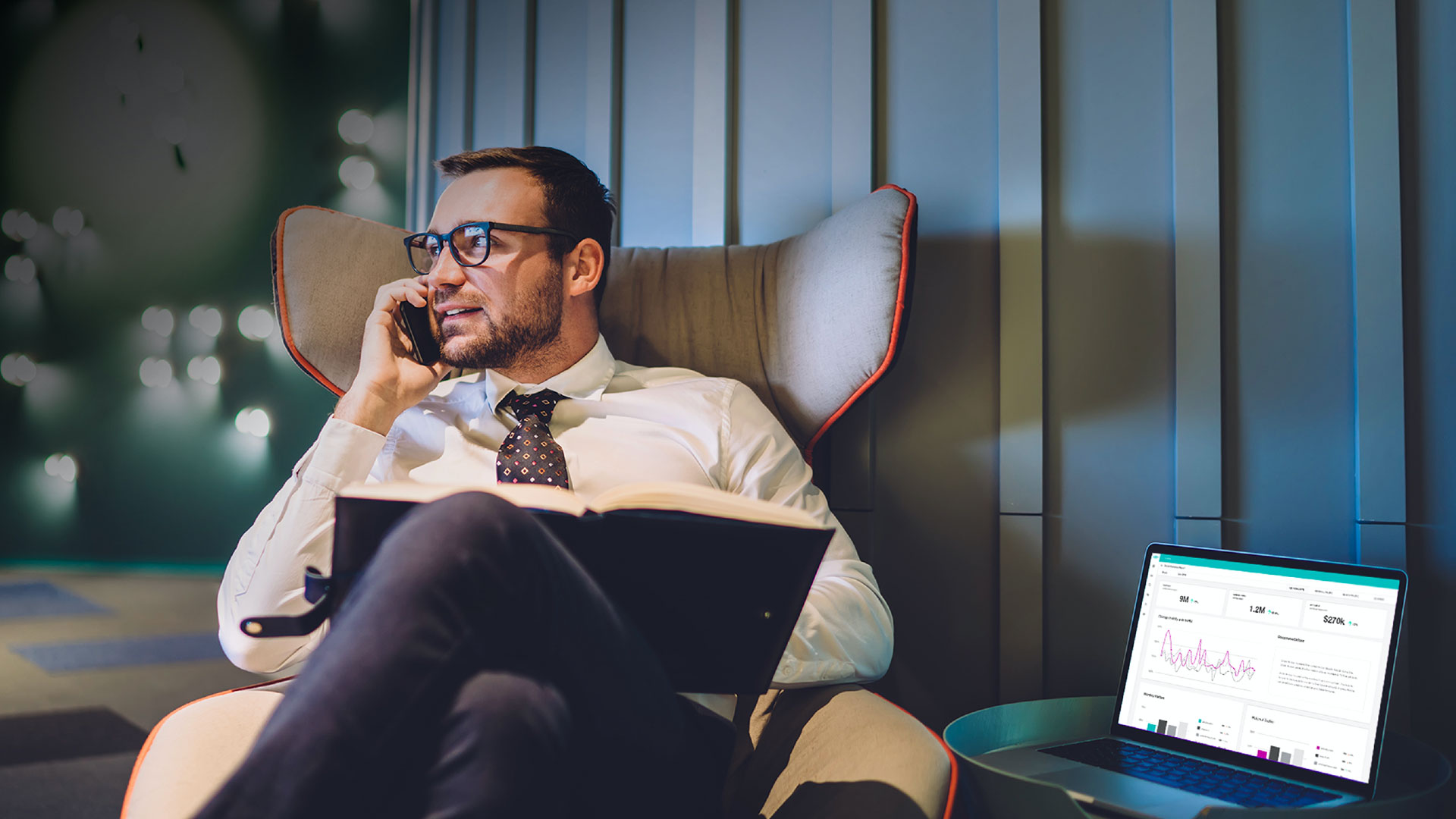 Photo of an executive in a chair working on his laptop