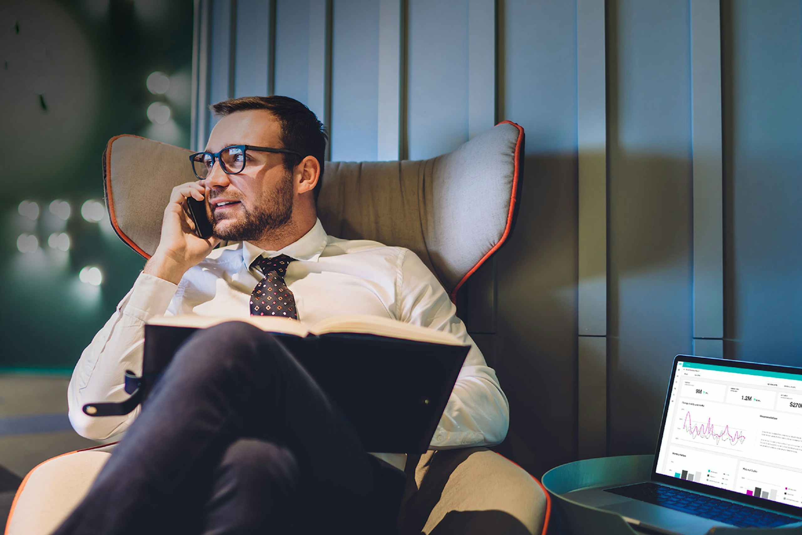 Photo of an executive in a chair working on his laptop