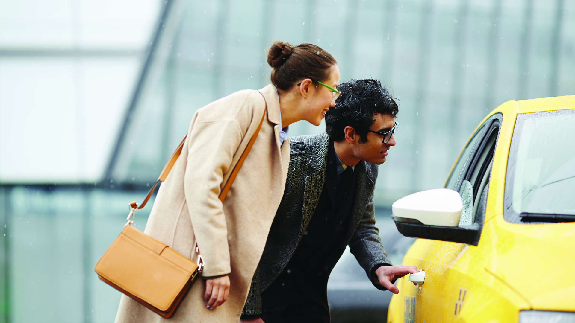 Two businesspeople hailing a cab or ride-sharing service