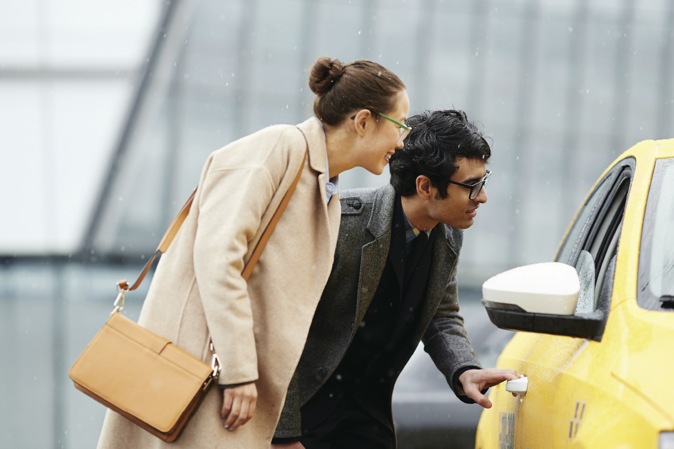 Two businesspeople hailing a cab or ride-sharing service