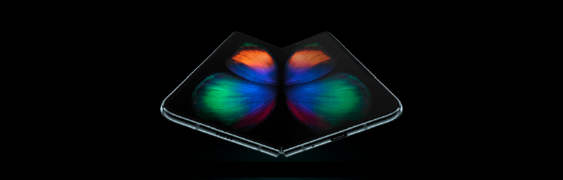 An open Samsung Fold cell phone with a colourful butterfly type image over both screens.