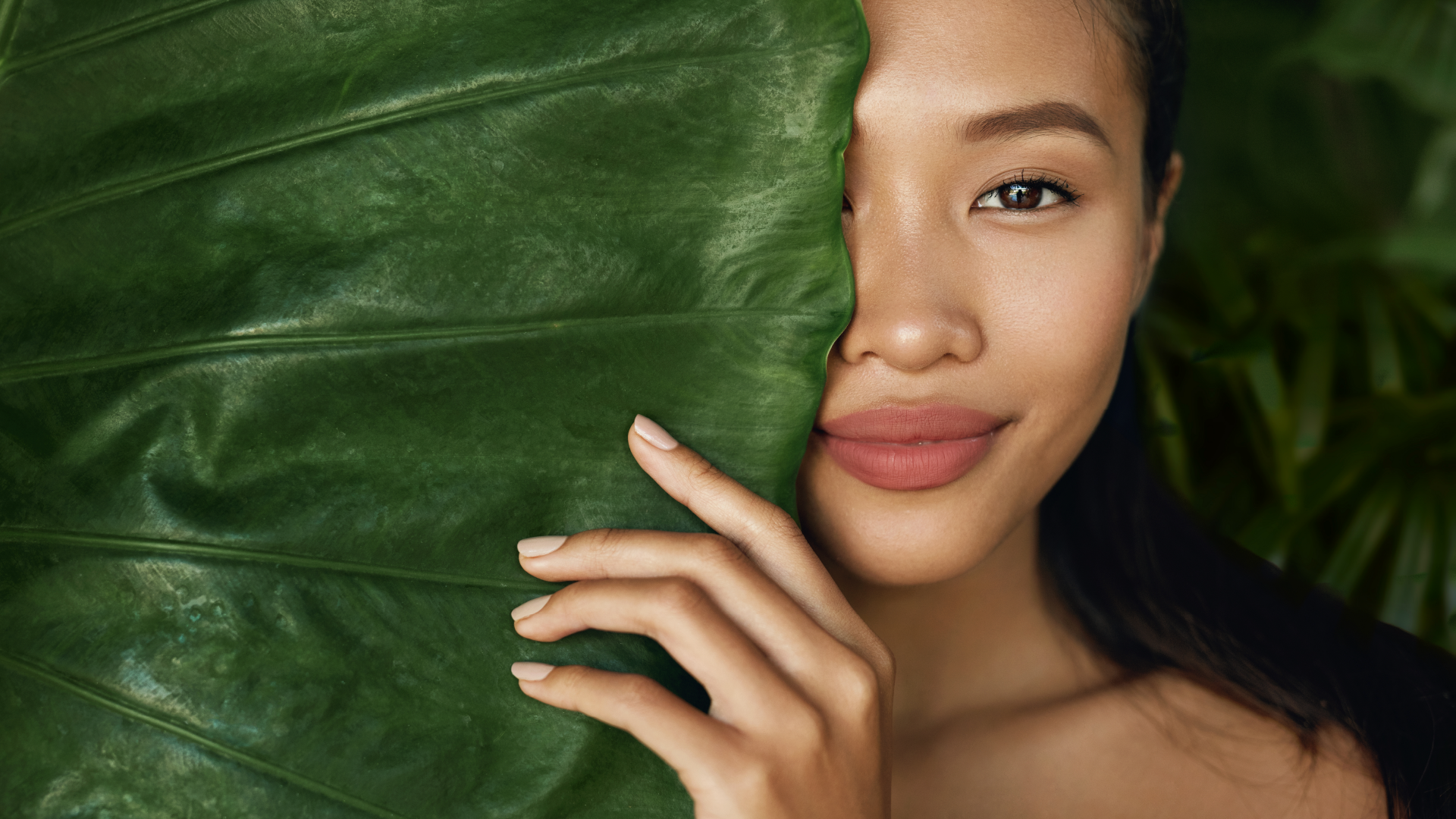Photo of an Asian face model with a leaf