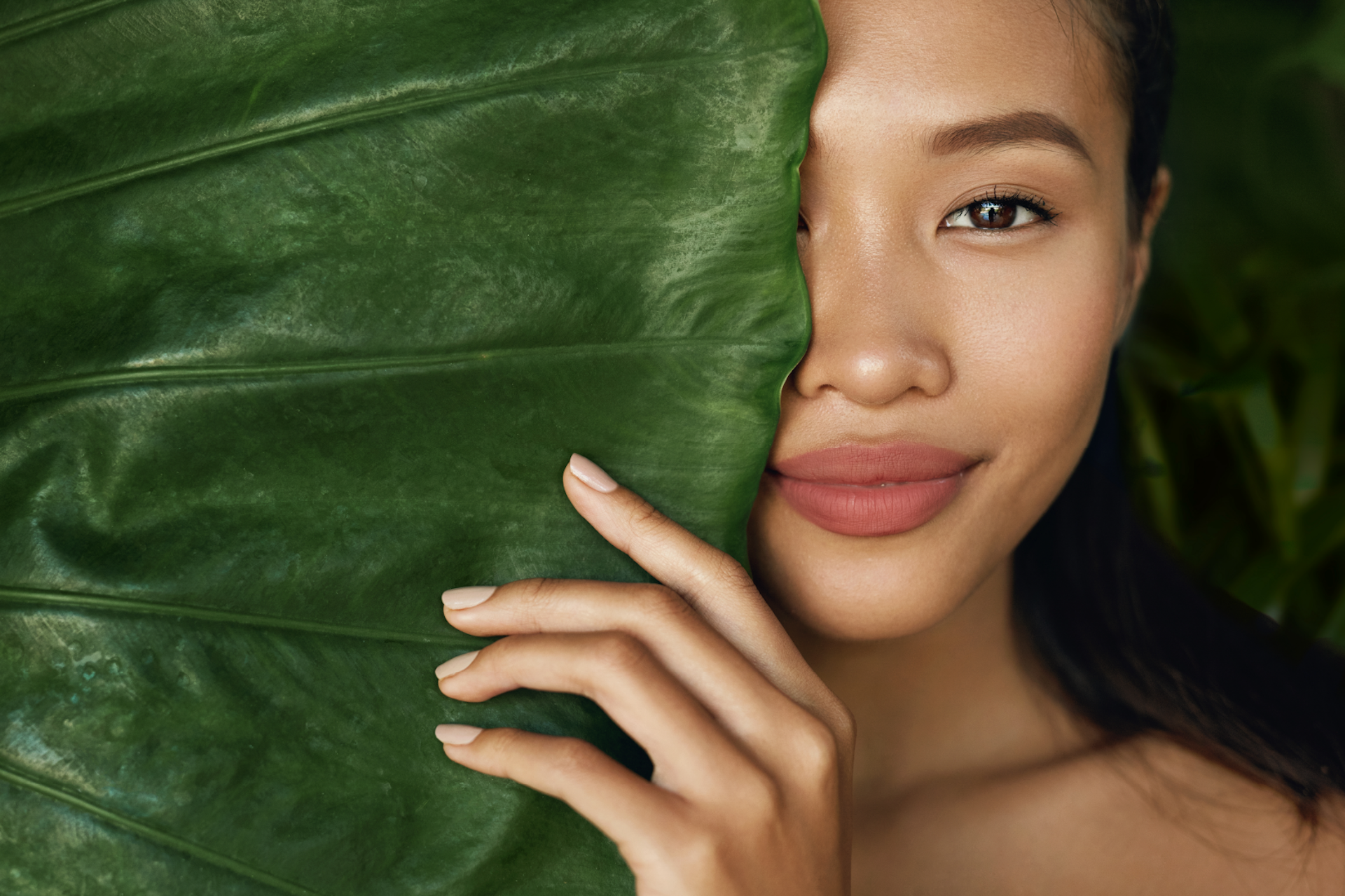 Photo of an Asian face model with a leaf