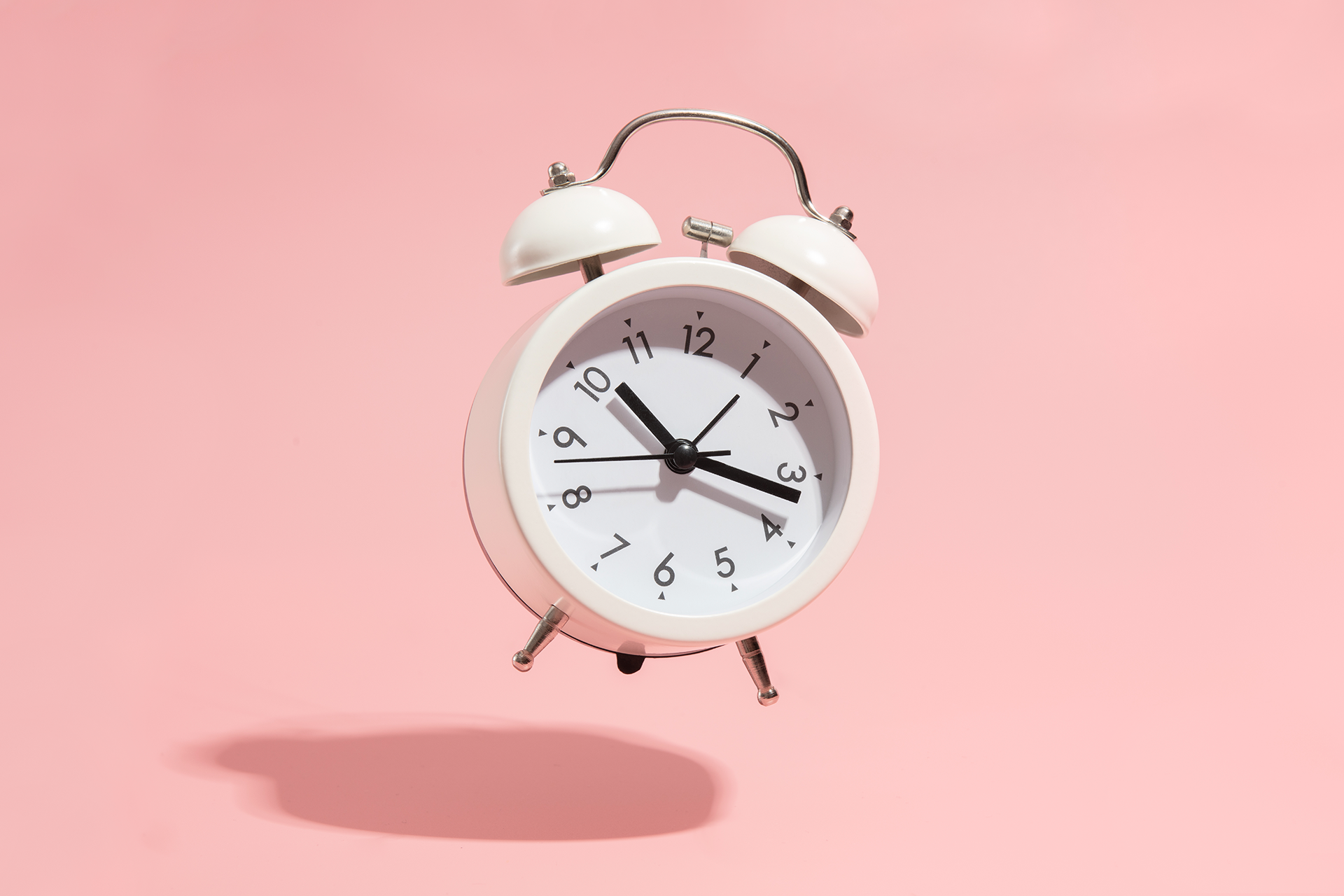 A white alarm clock is floating in the air because it is ringing so hard. This alarm clock was set to go off to remind us of the importance of real-time marketing in our strategies.