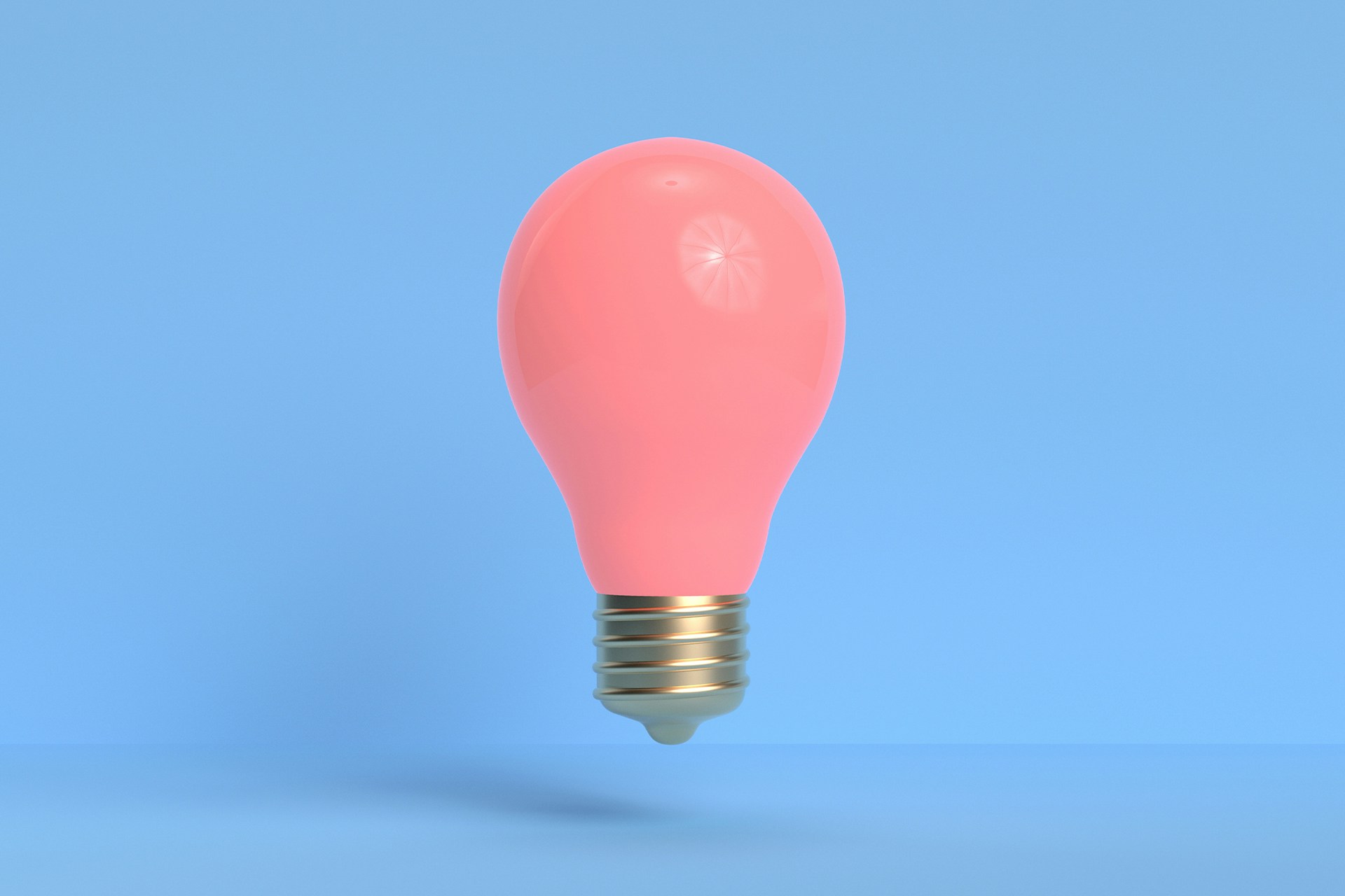 A bright pink lightbulb hovering in the air in front of a pale blue background. This image is used to describe a blog post outlining several ideas on how to use social walls in your marketing campaigns.