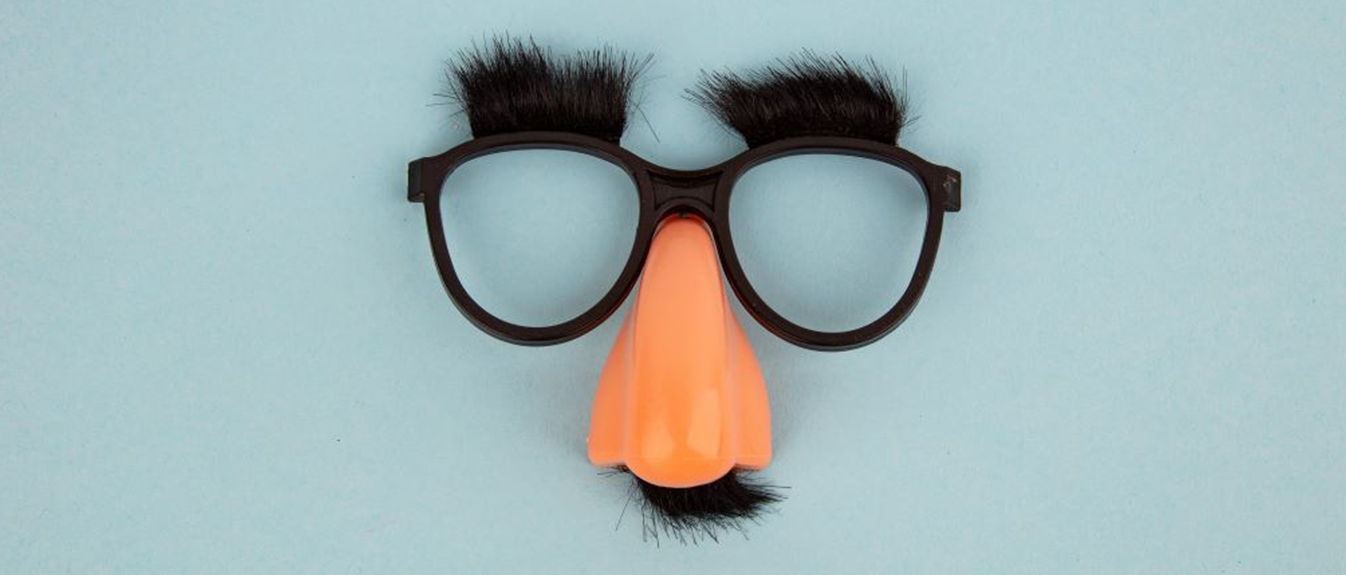 An image of a pair of Groucho Marx glasses, with a large nose, large eyebrows, and mustache