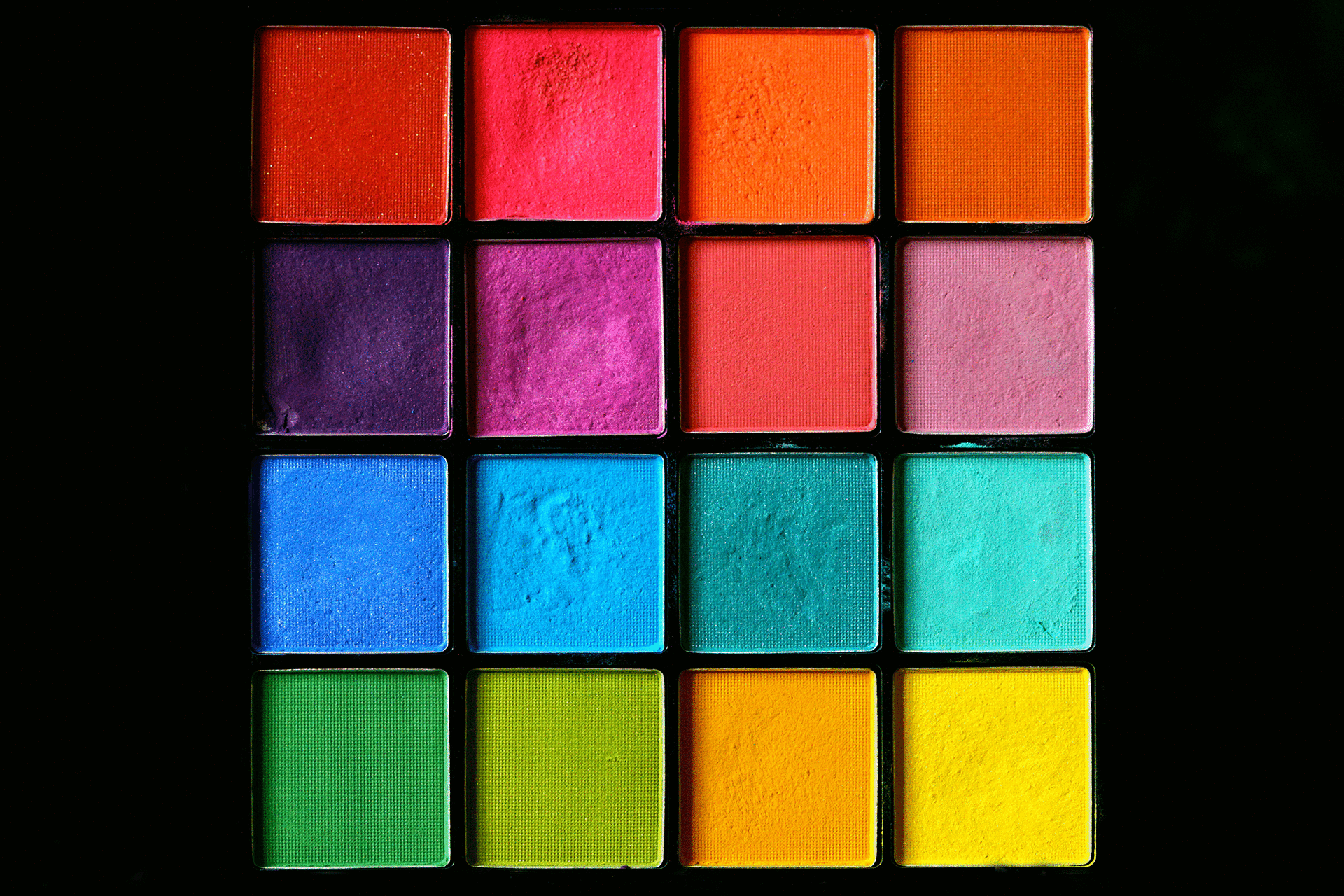 photo of a colorful makeup palette with a black background