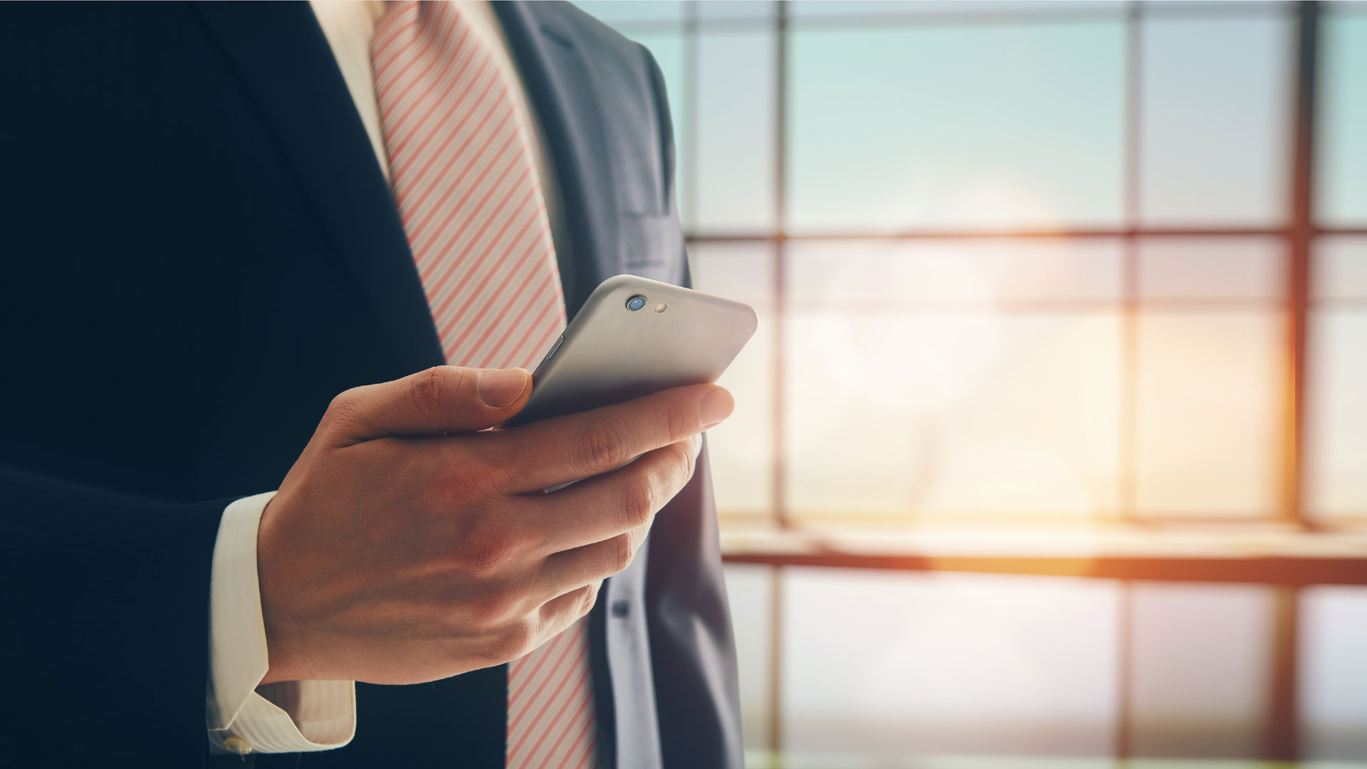 Photo of a business man holding a smartphone