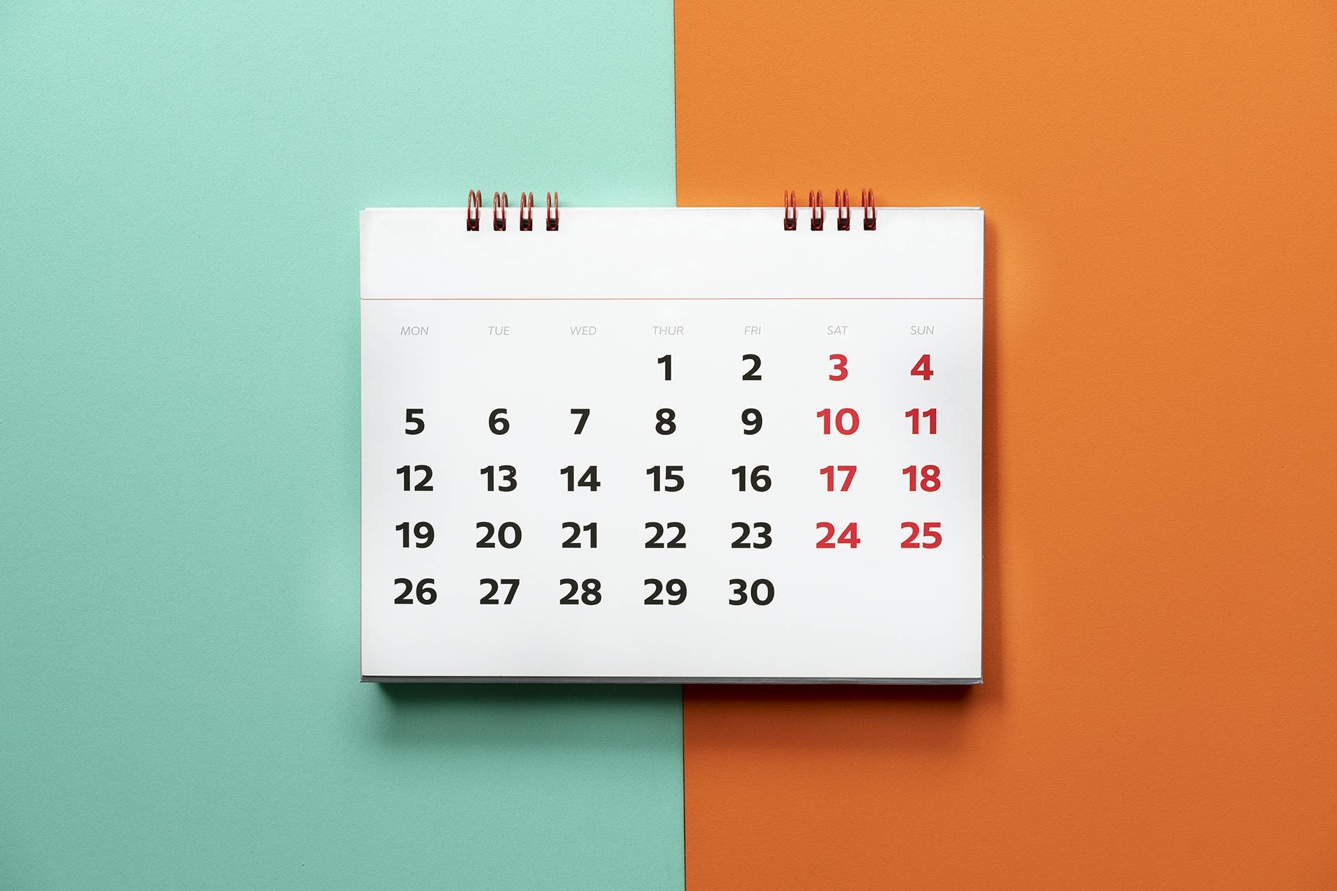 green and orange background with a calendar in the foreground