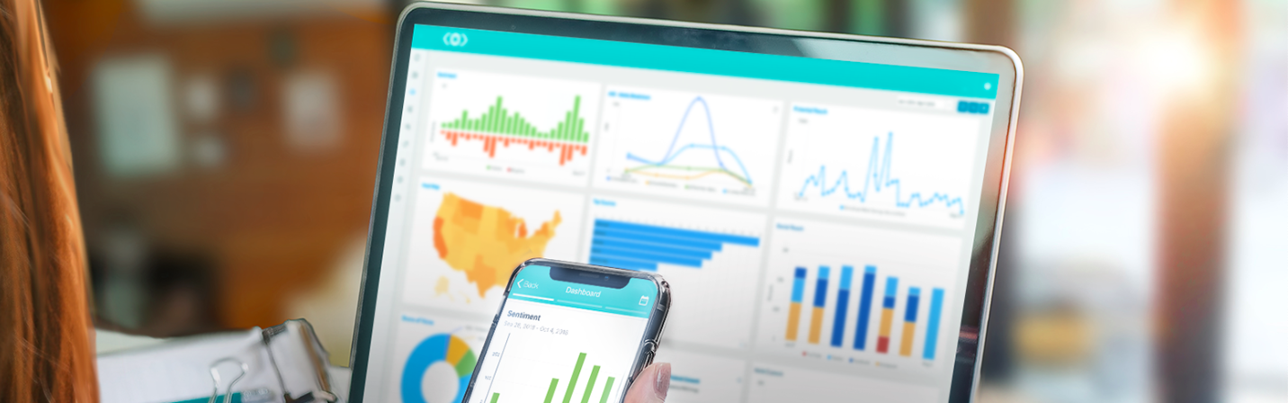 Laptop and cell phone both depicting charts and graphs.