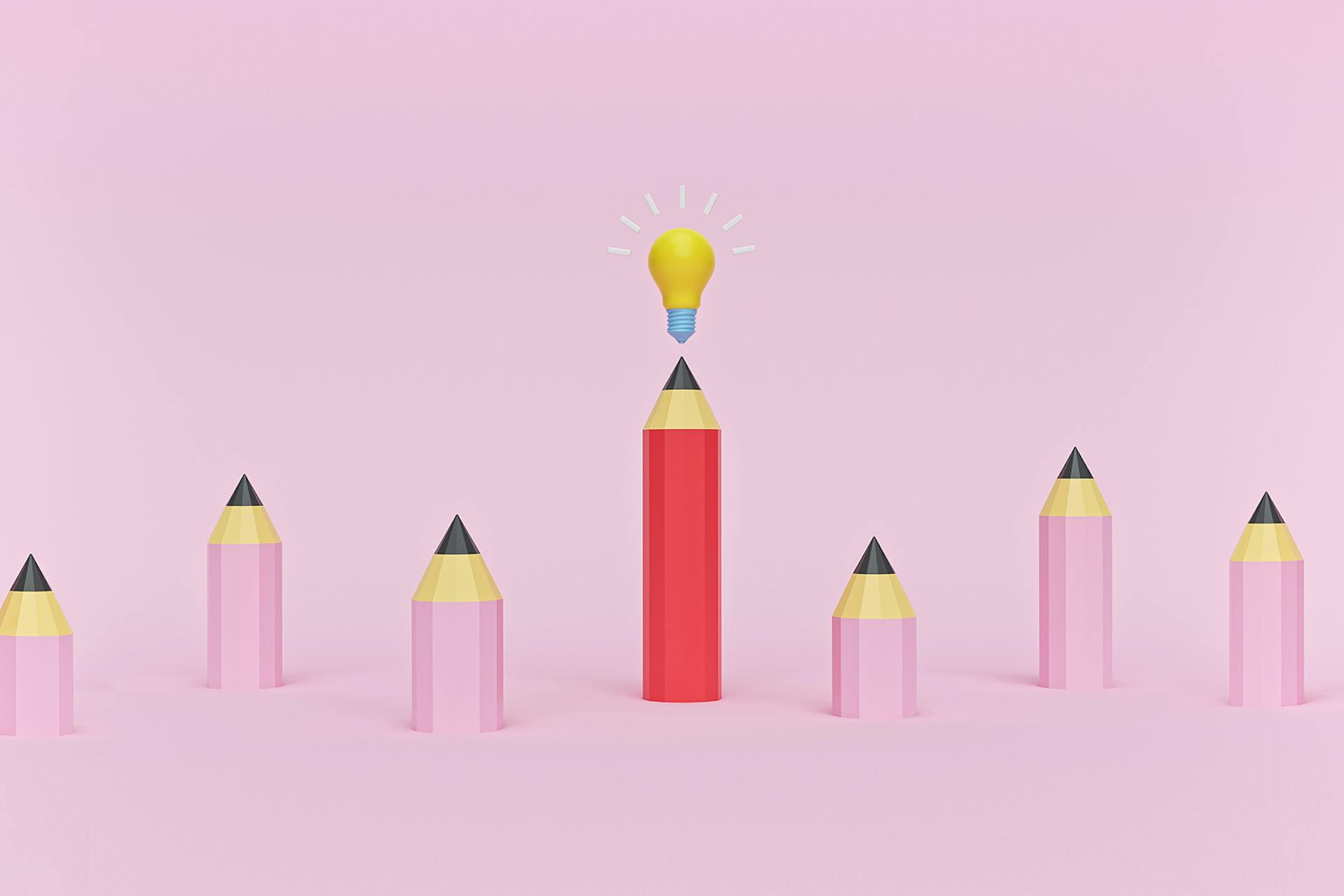 A group of six small pink pencils and a large red pencil with a lightbulb on top of it. This image describes the process a writer or marketer may go through when developing content marketing ideas. 