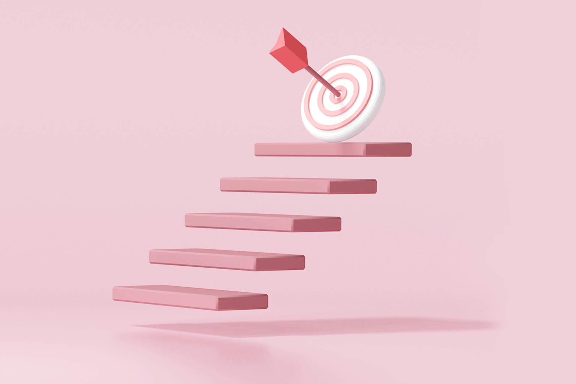 Image showing a floating pink staircase leading up to a target with an arrow in the bullseye, on a pale pink background. Achieving Instagram impressions and reach blog post
