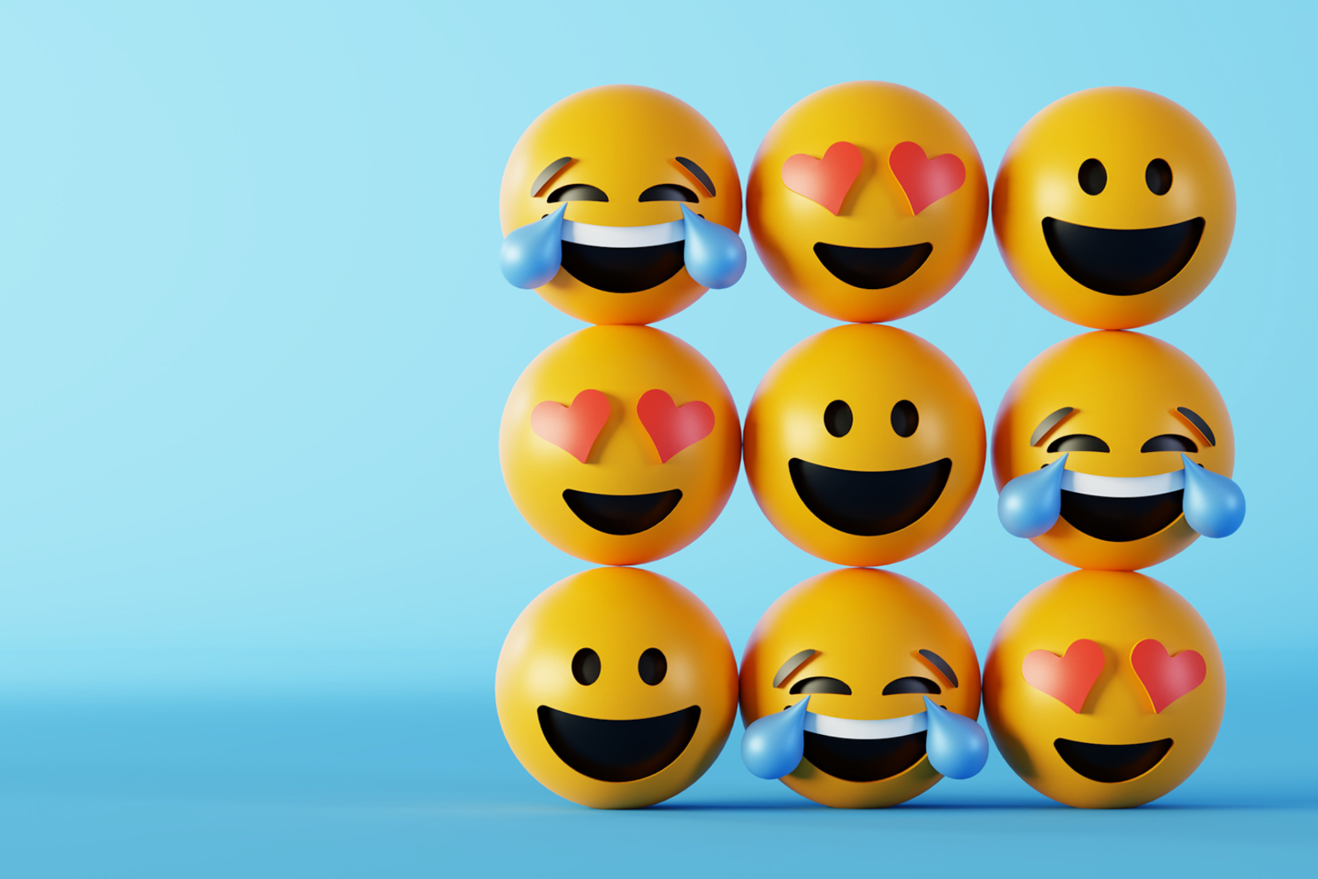 Smiling, crying laughing, and heart eyes emojis arranged in a 3x3 grid against a blue background for a Meltwater social listening analysis blog about the top emojis of 2024.
