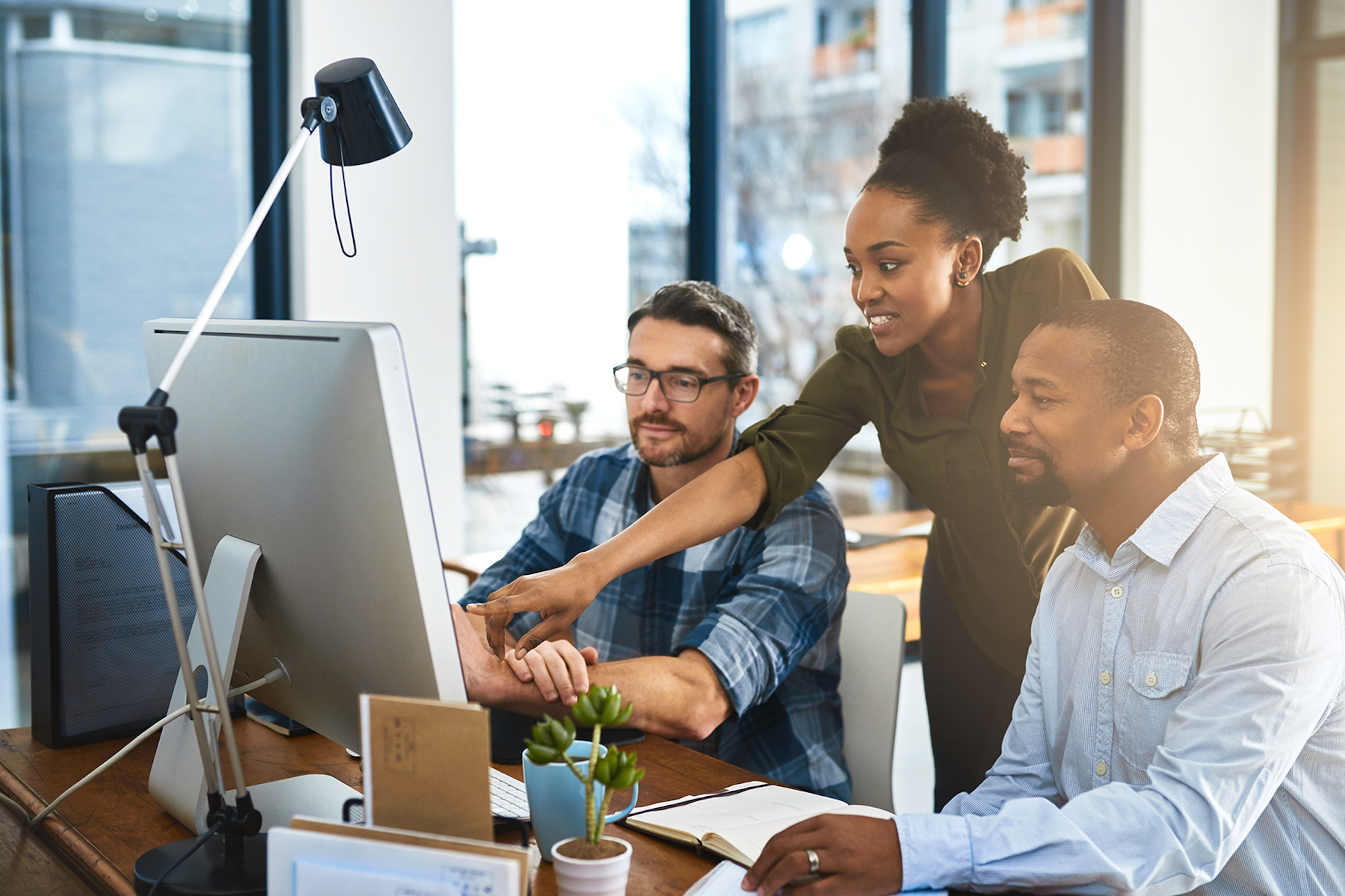 Marketing professionals looking at a computer screen.