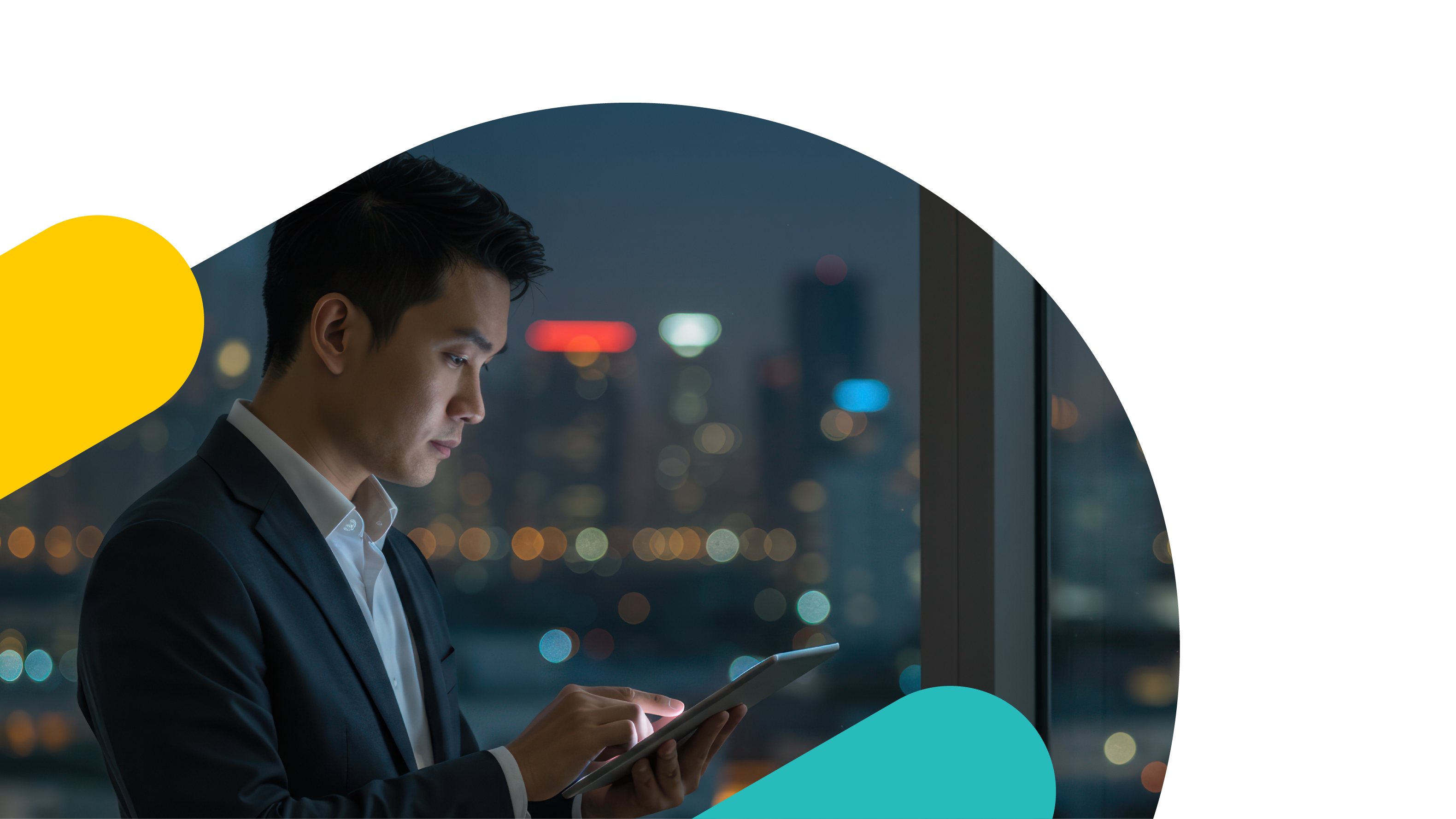 An asian man in a suit working on this tablet