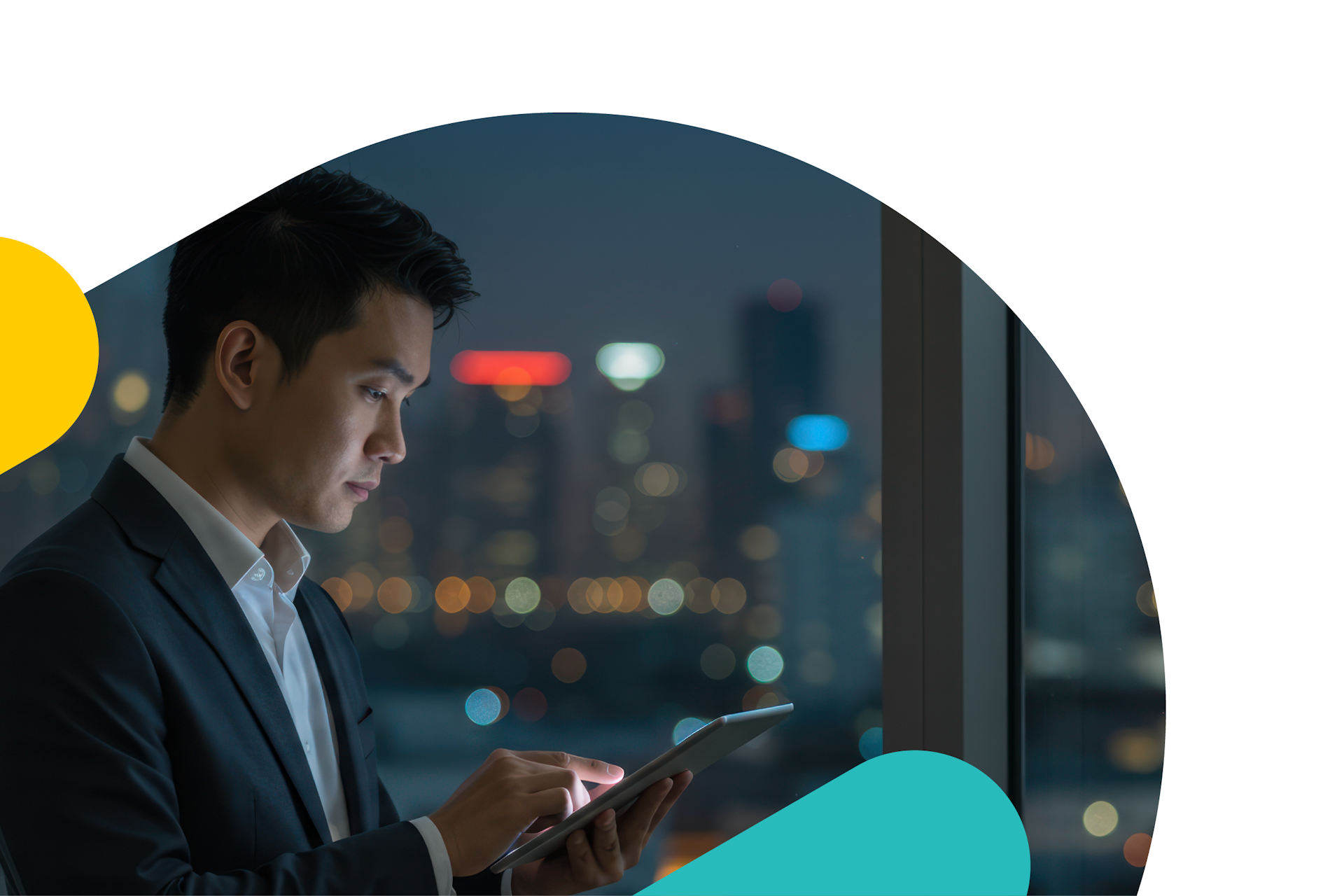 An asian man in a suit working on this tablet