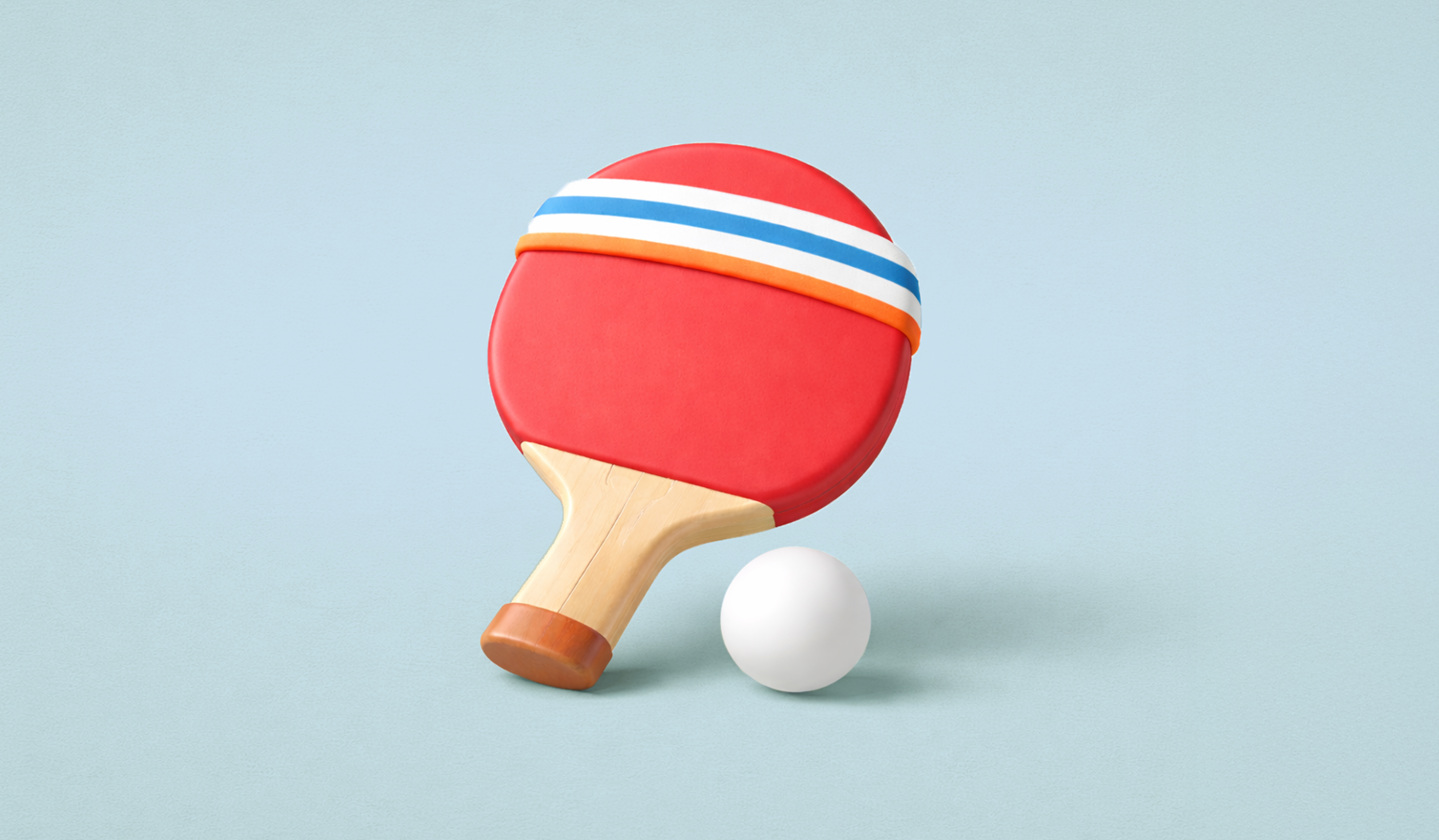 A white ping pong ball beside a red ping pong paddle against a light blue background.