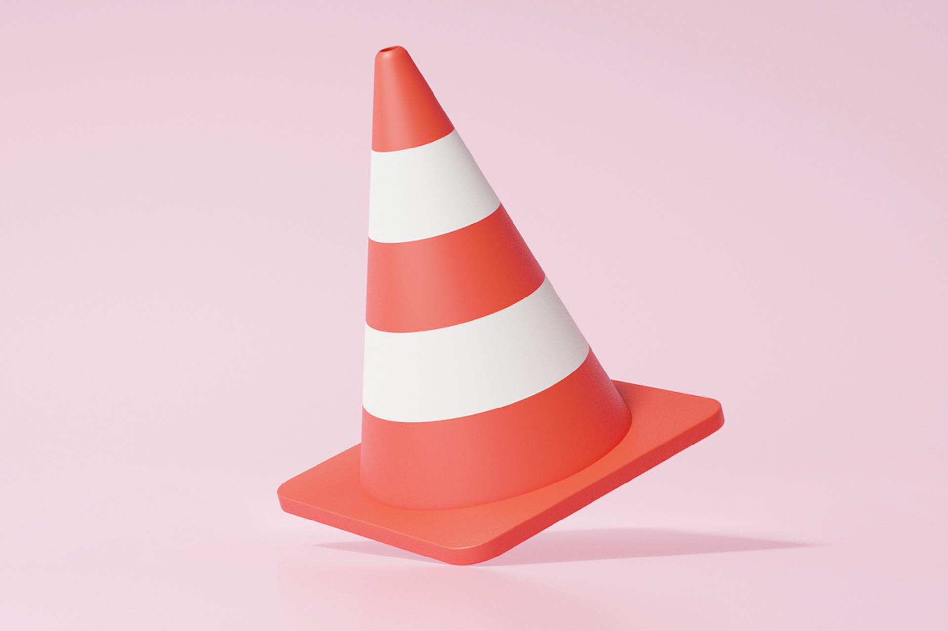 An illustration of a red traffic cone that has two white stripes on it. A traffic cone, like this, often acts as a warning signal, which it is being used as the header image for a blog on Barriers to Effective Communication & How to Overcome Them.