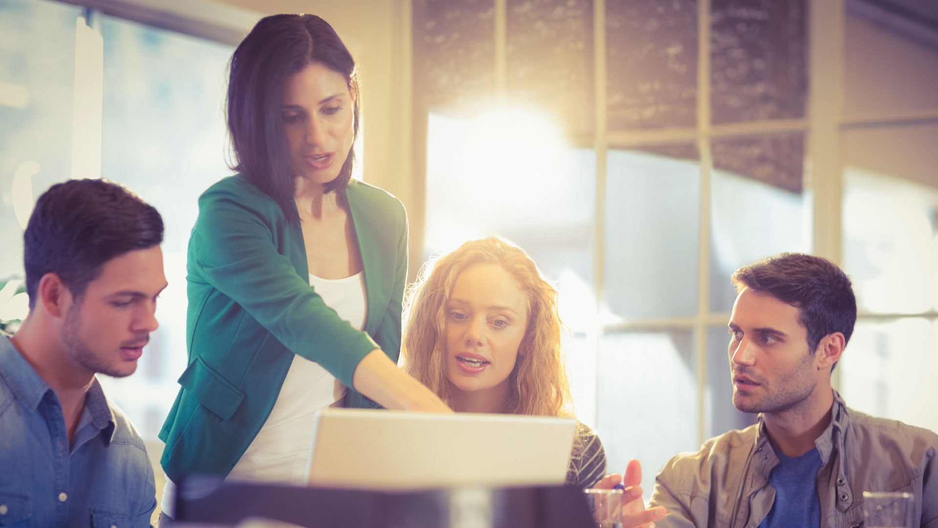 Photo of a woman showing her coworkers something