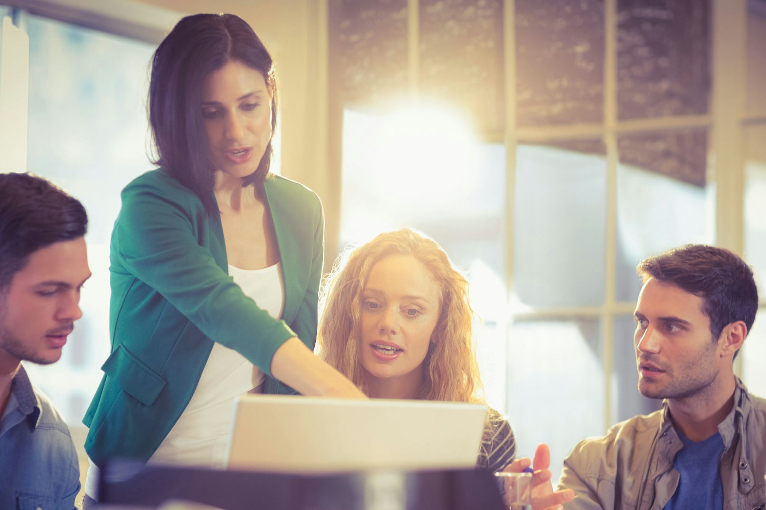 Photo of a woman showing her coworkers something