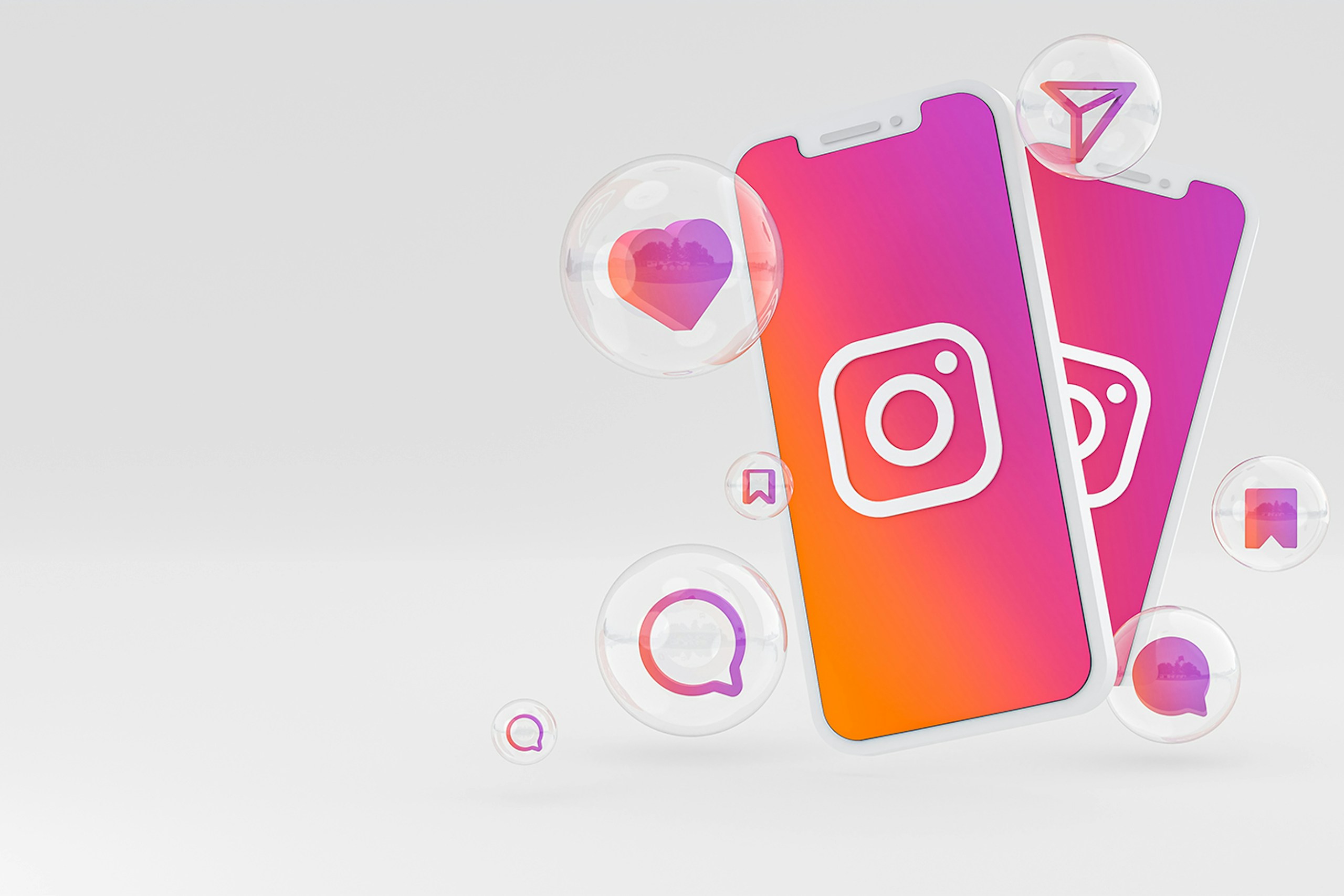 インスタグラムのロゴが表示されているスマートフォン2台が重なり、いいねやコメントのアイコンと共に白い背景に配置されている3Dレンダー画像