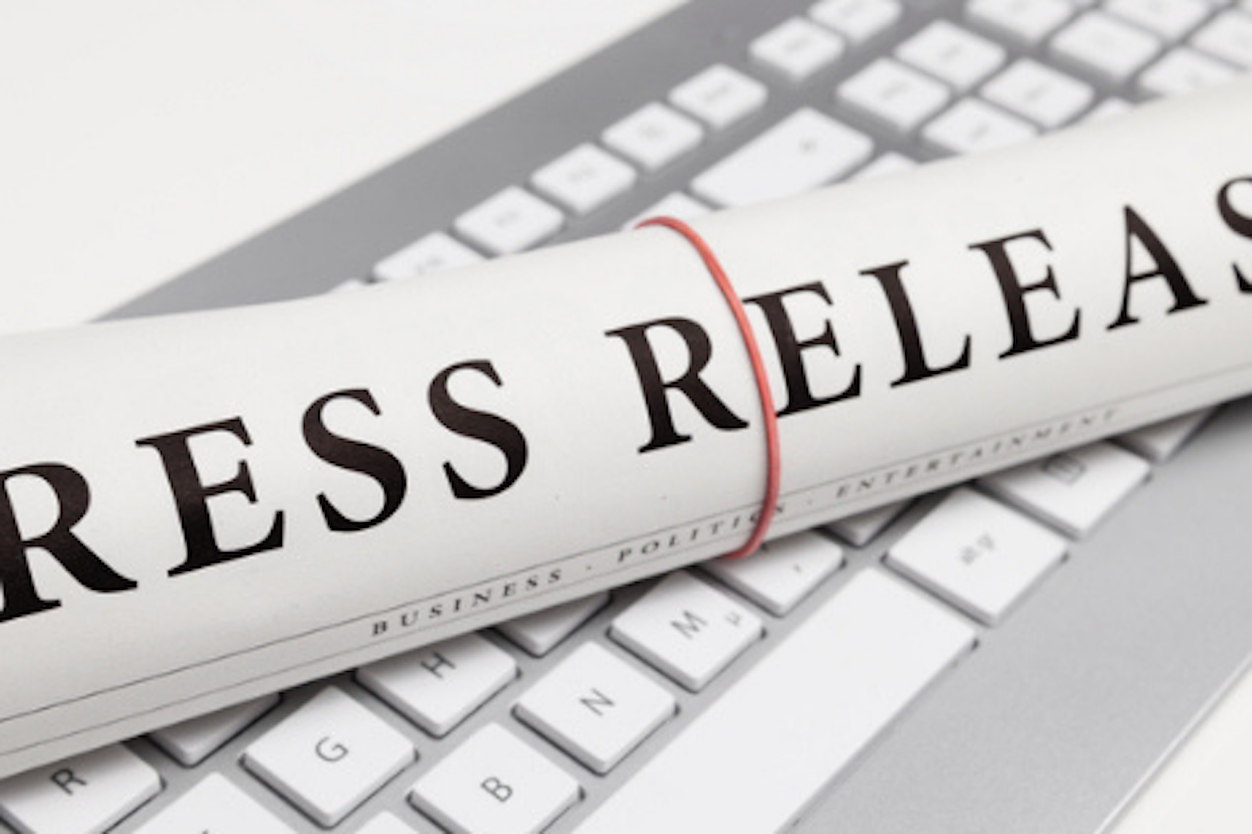 Photo of a newspaper on a keyboard saying press release