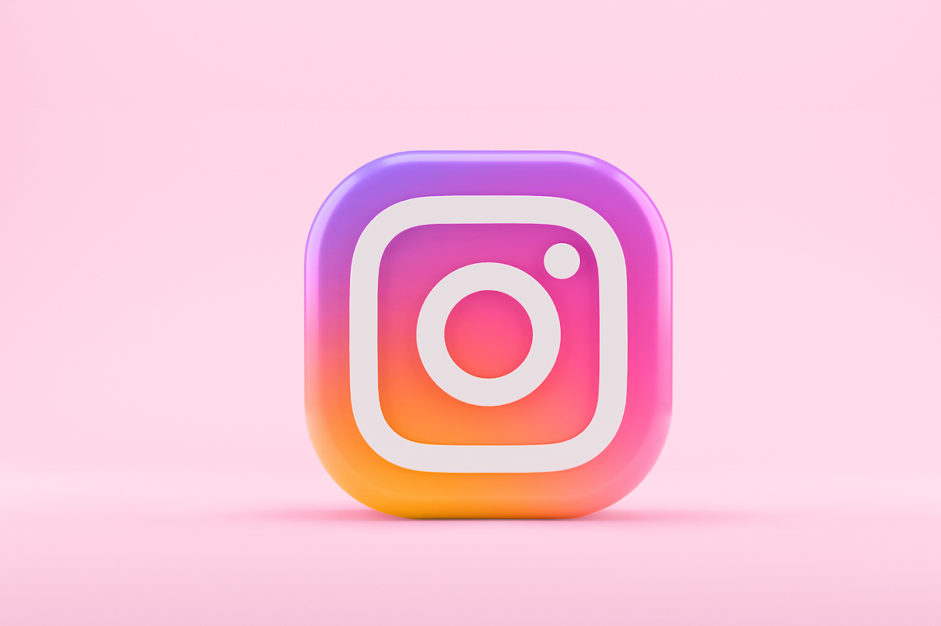 A giant Instagram logo with a pink background. This image is being used in a blog post announcing the release of scheduling and publishing for Instagram Stories and Carousel posts through Meltwater. 