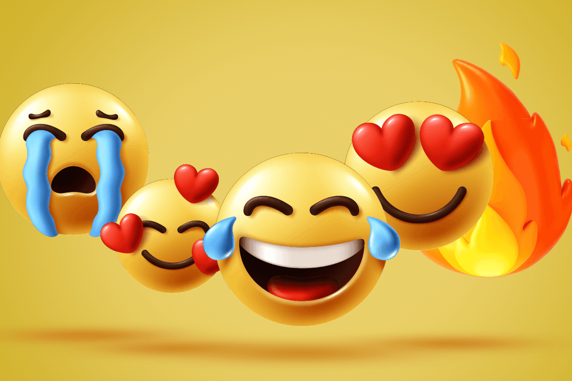The sobbing, smiling face with hearts, laughing with tears of joy, smiling with heart eyes, and fire emojis for a Meltwater social listening blog about the most-used emojis of 2023.