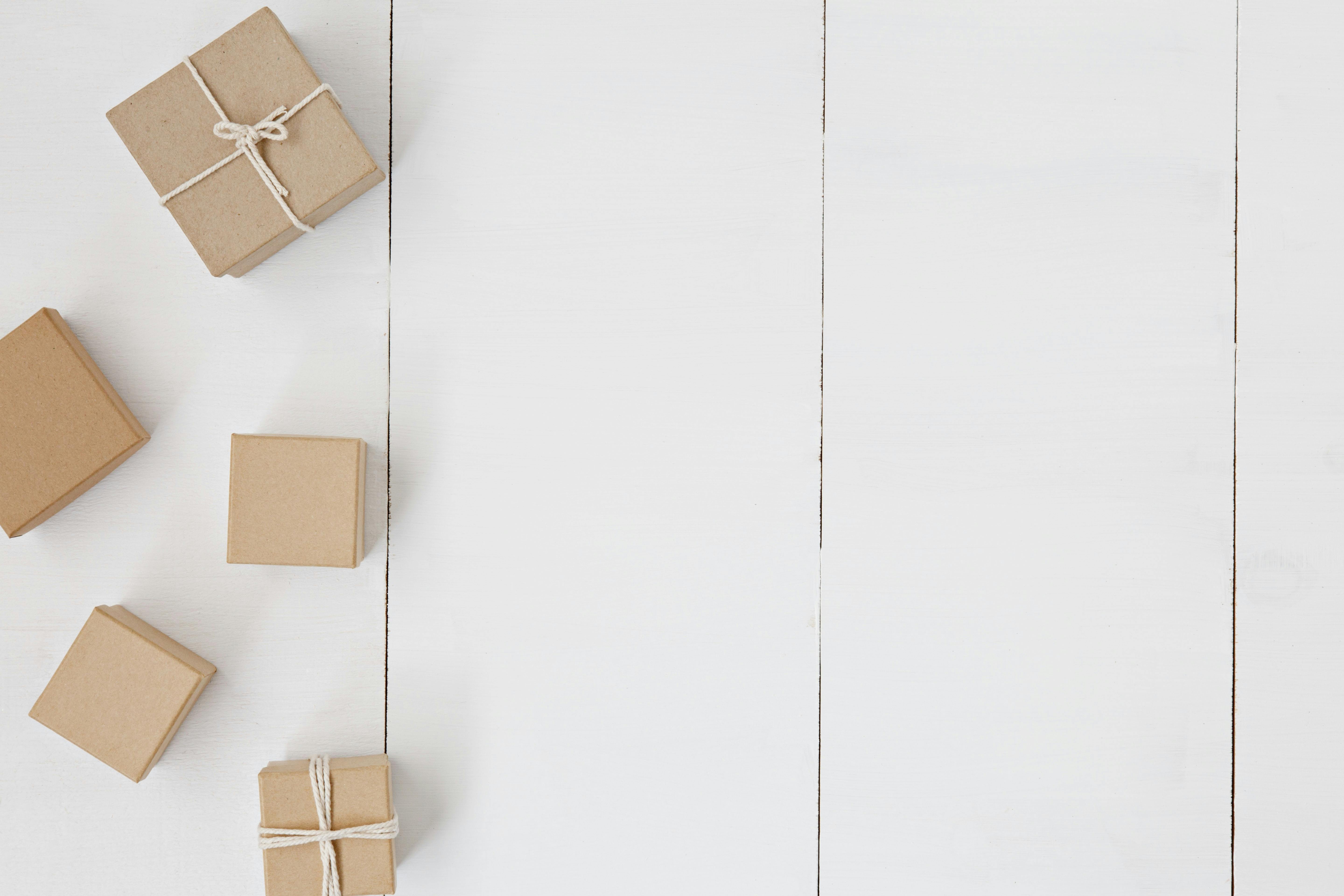 Brown boxes with ribbons on white background. Subscriber only gifts on YouTube is a great idea for keeping people engaged