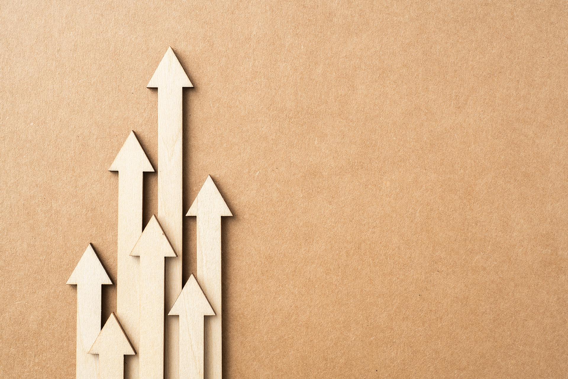 A series of wooden arrows pointing upwards -- the direction you want your Instagram engagement to head in.