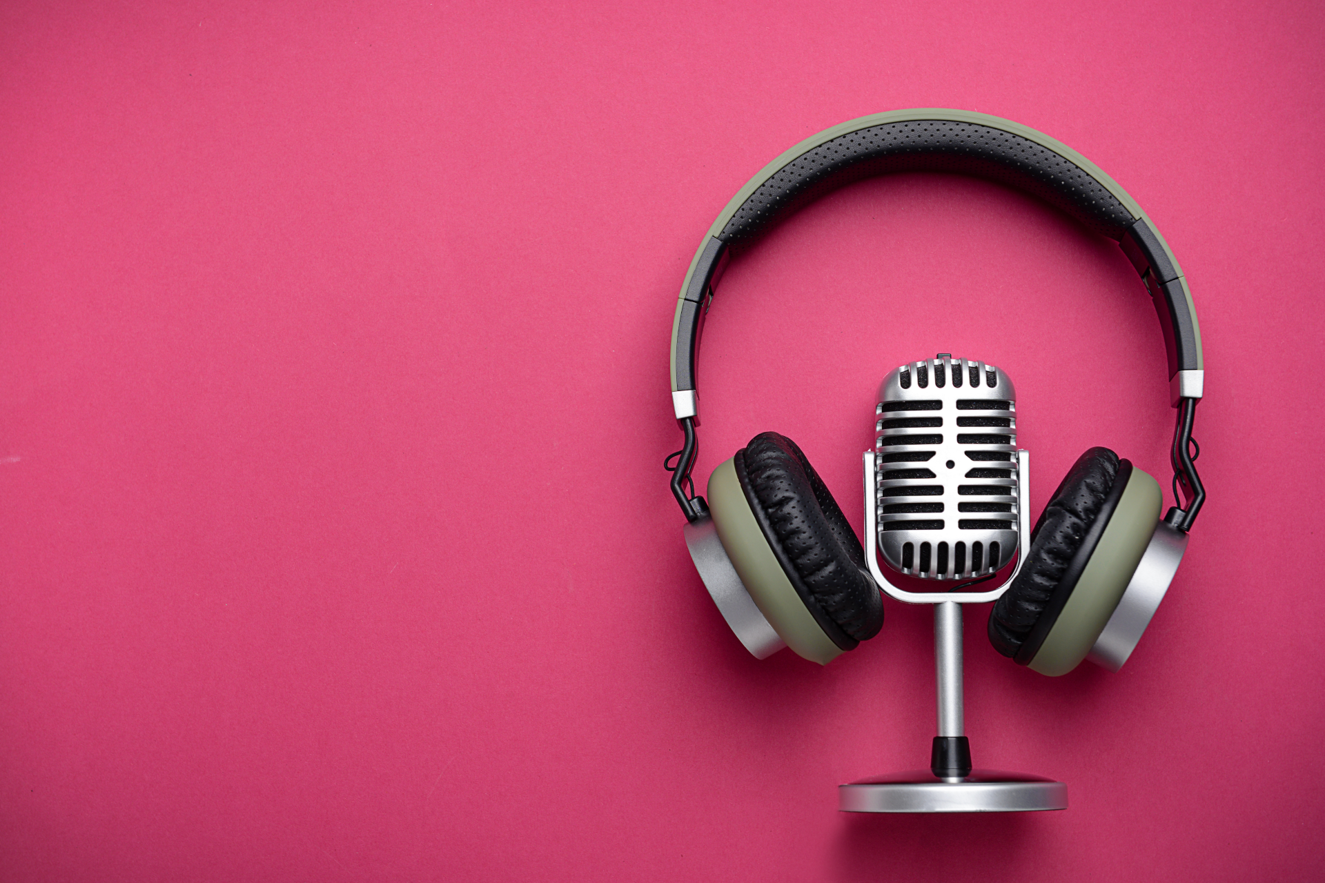 Microphone and headphones on a pink background