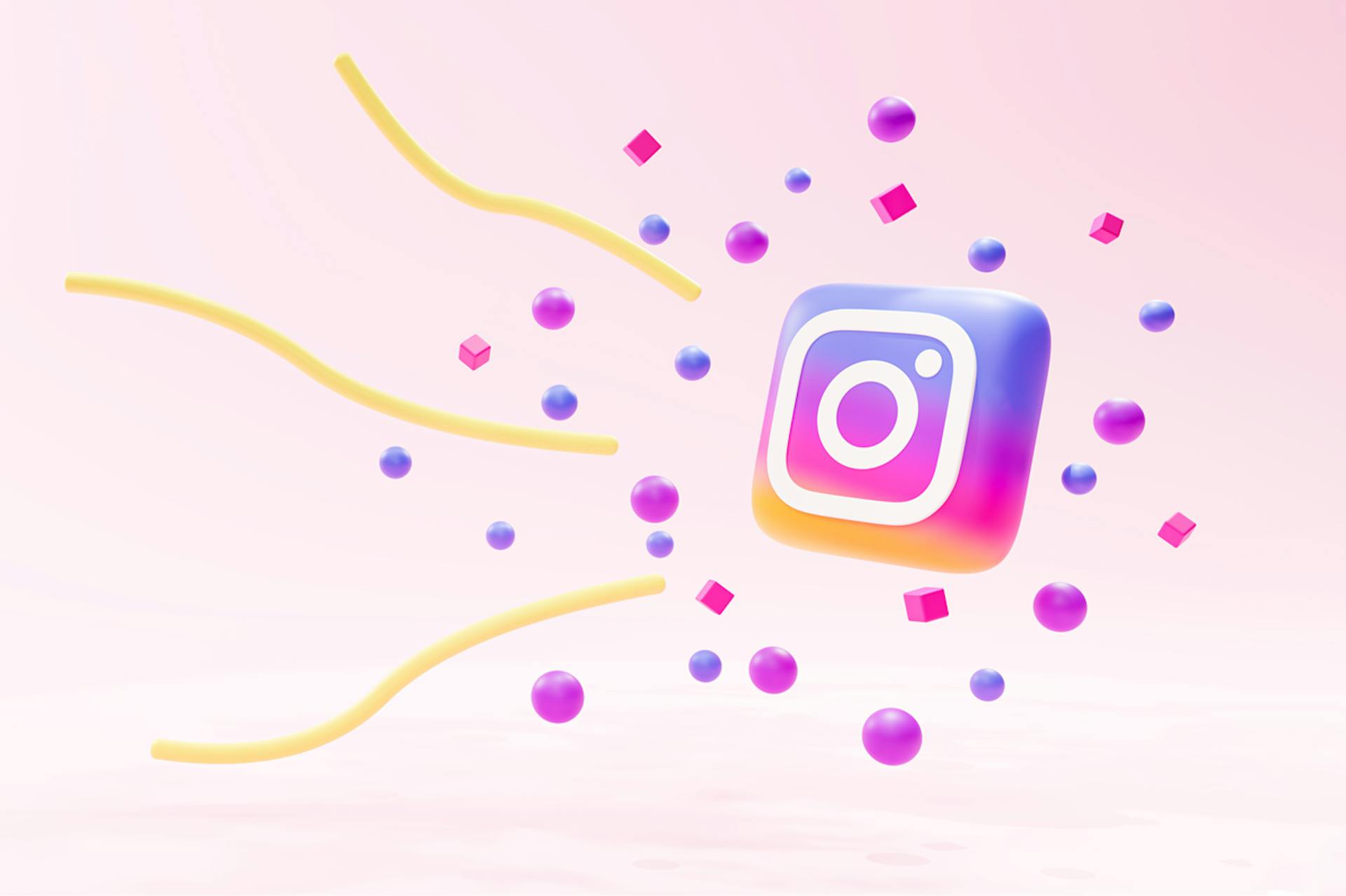 Instagram trends blog post. Image showing Instagram logo on pale pink background surrounded by multi-colored dots and yellow squiggly lines