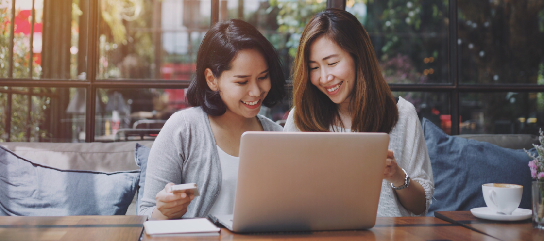 Photo of two people looking at a laptop