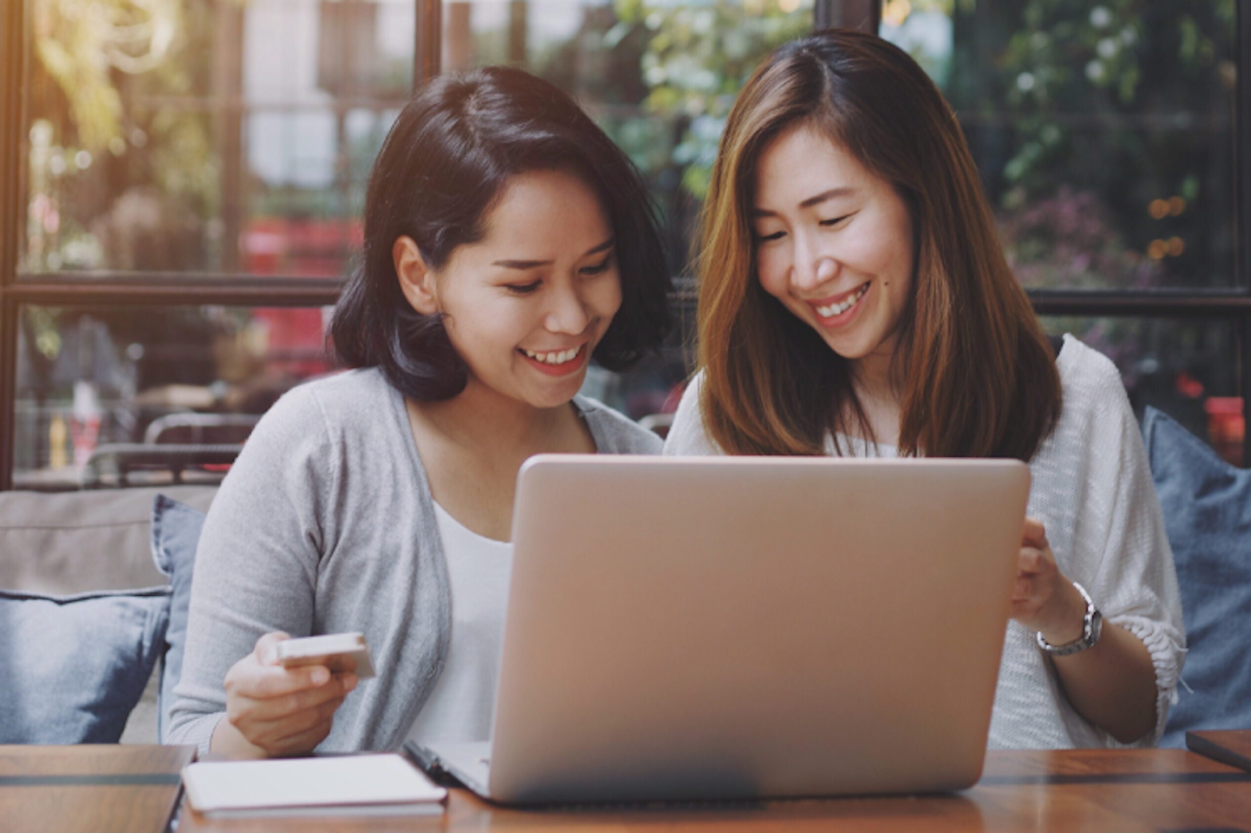 Photo of two people looking at a laptop