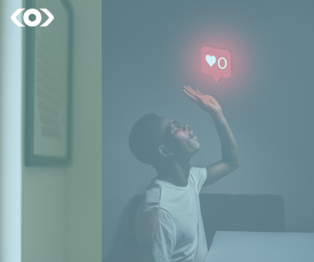 Photo of a man holding up a digital like icon from Instagram