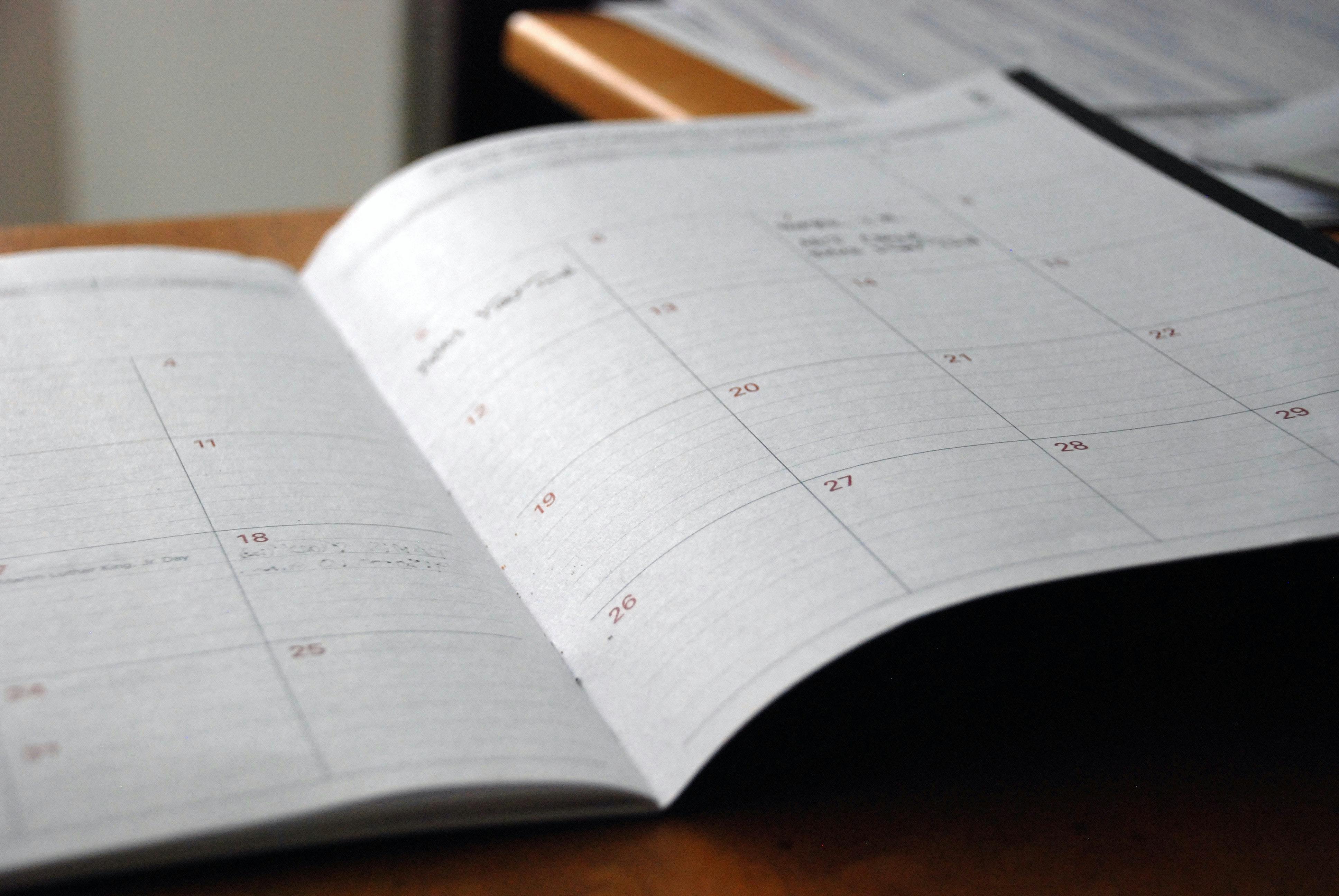 Open monthly planner showing month view of dates. Planning and sticking to a content schedule is essential for growing your YouTube subscriber count