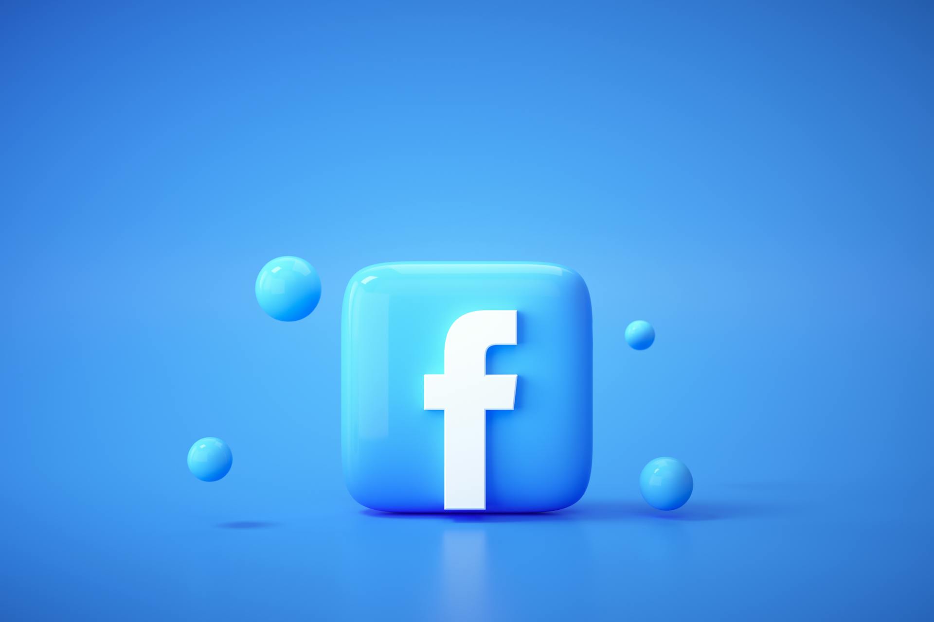 青い背景にFacebookロゴと青い球体が配置されているの3Dレンダー画像
