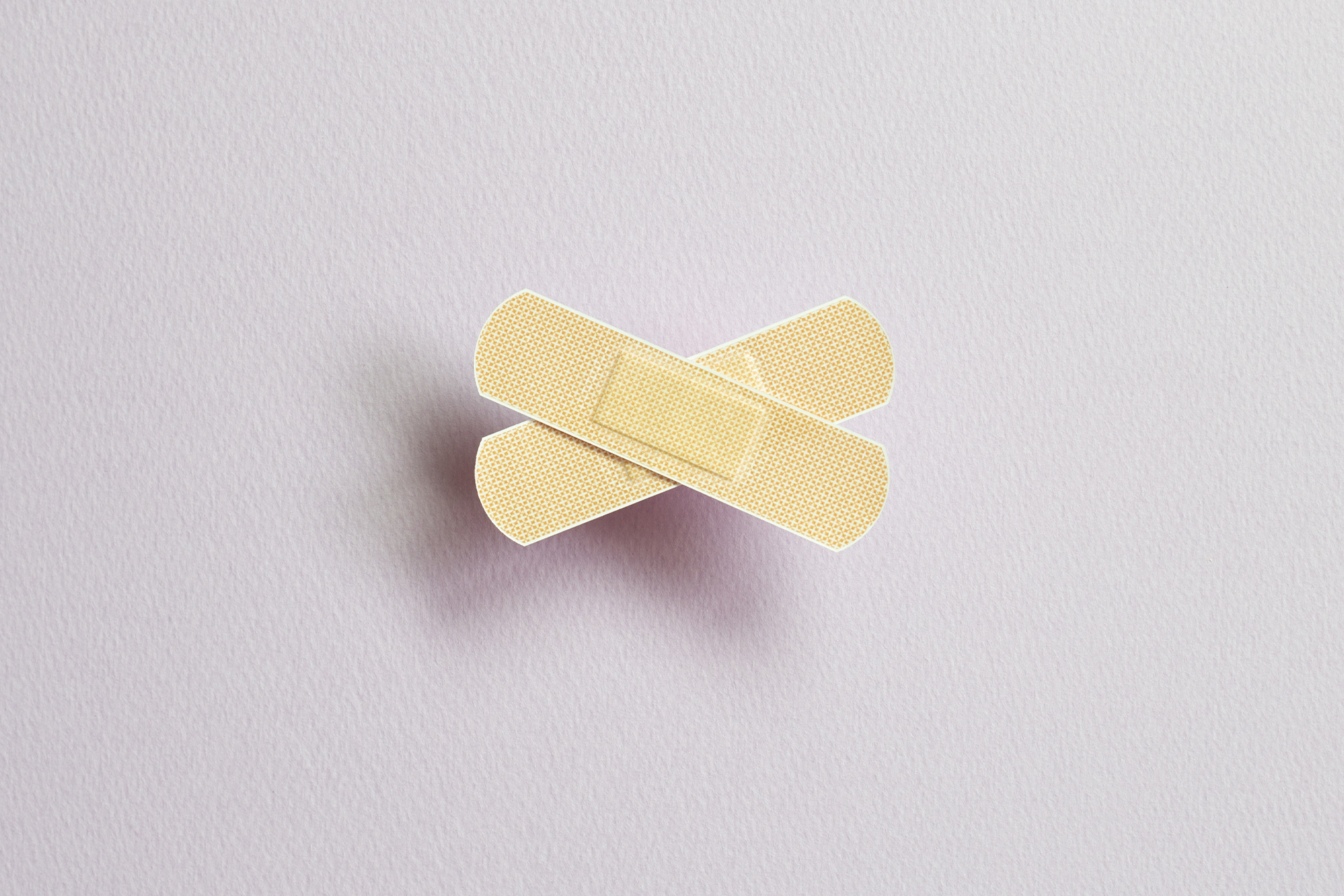 Two bandaids forming a cross shape. Tips for writing a crisis statement blog post