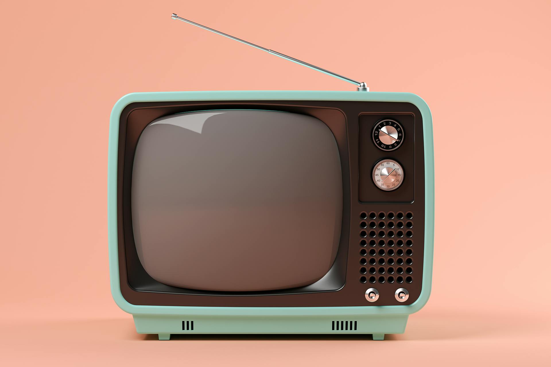 A blue and black retro television with a leaning antenna set against a coral pink background