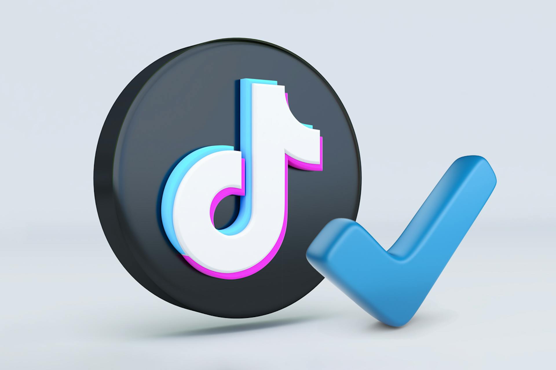 Illustration showing large TikTok logo next to a large blue checkmark. Tips for getting verified on TikTok blog post